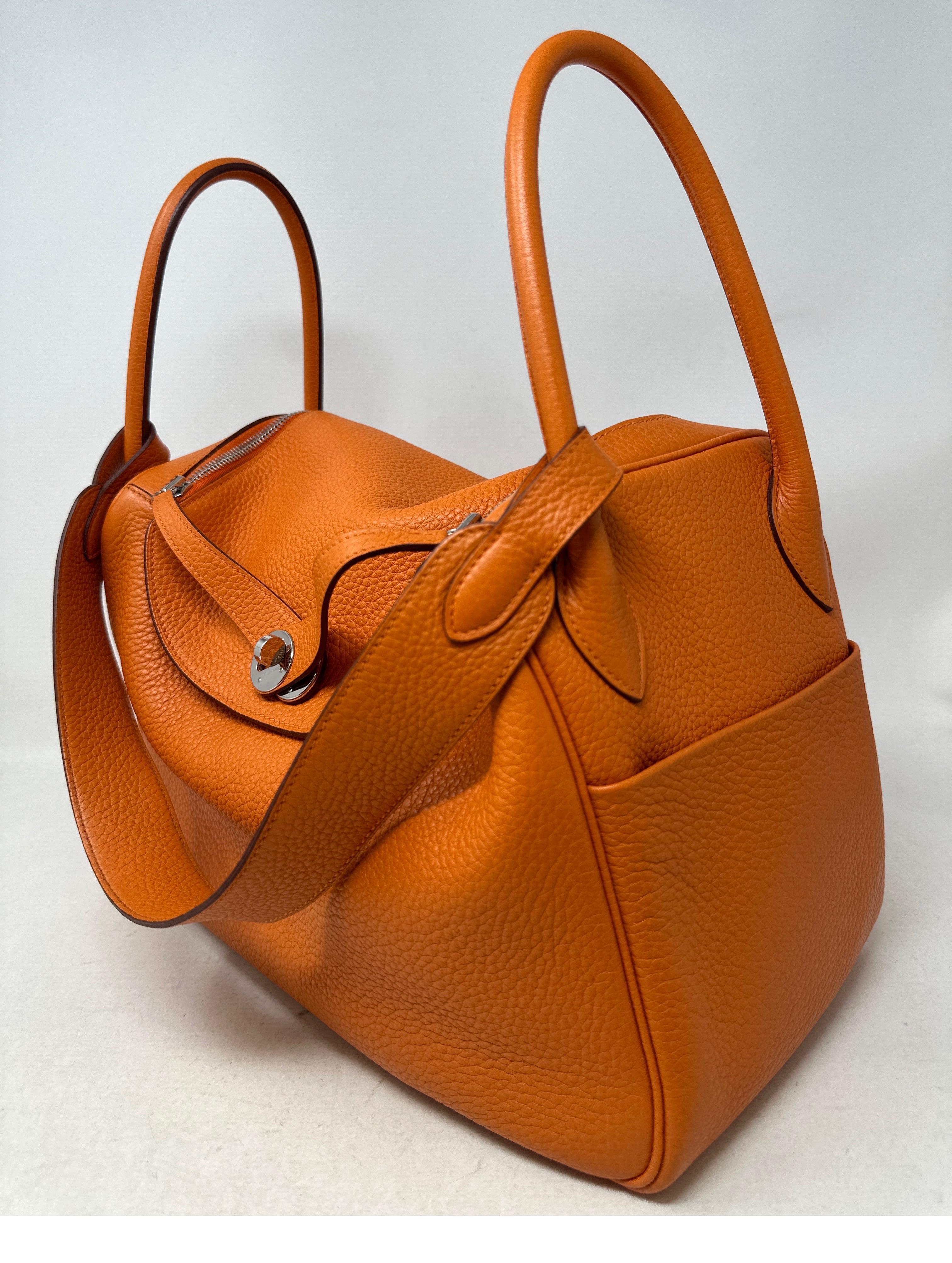 Hermes Orange Lindy Bag. Excellent like new condition. Hard to find Lindy bag. Togo leather. Palladium silver hardware. Size 34. Includes dust bag and box. Guaranteed authentic. 