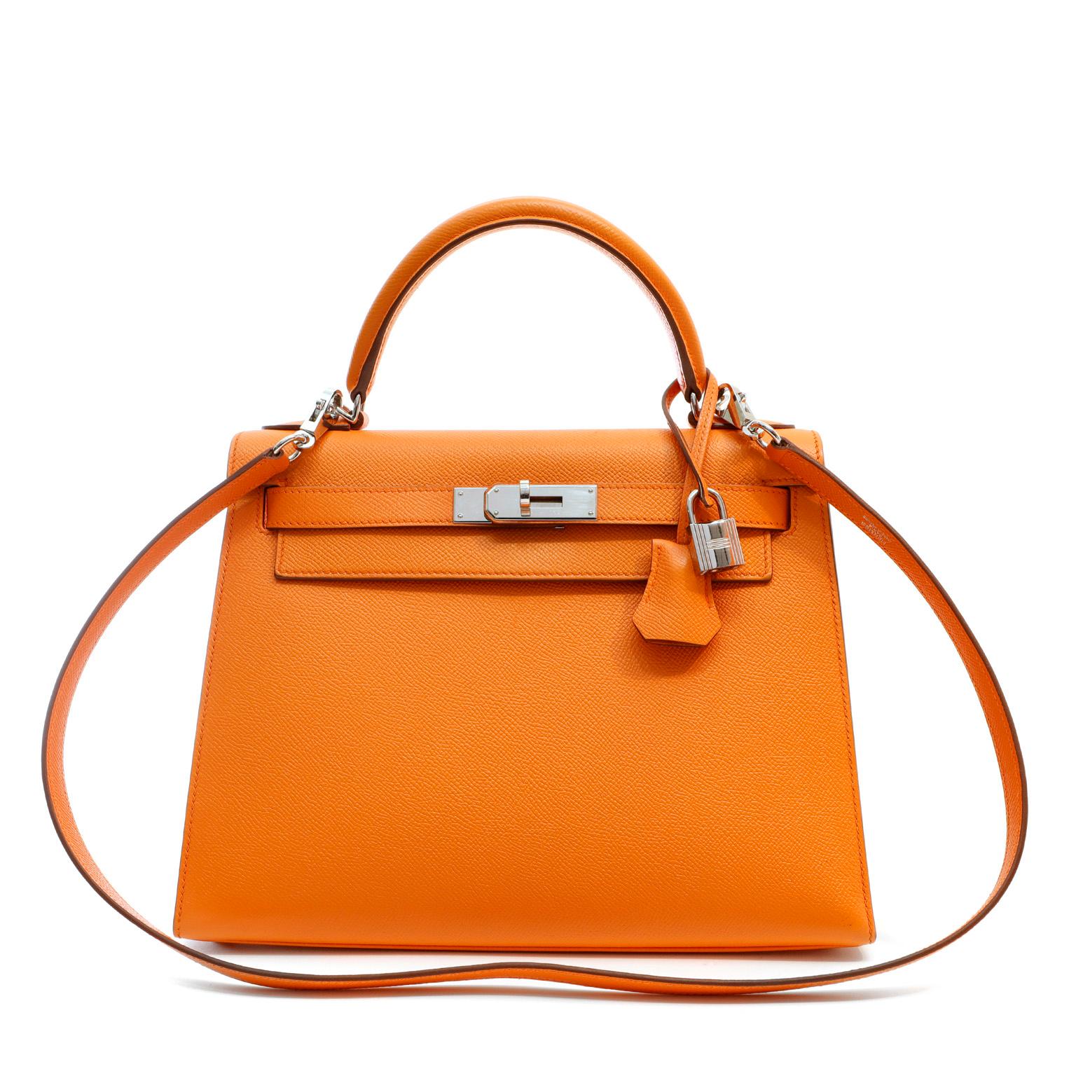This authentic Hermès Orange Epsom 28 cm Kelly Sellier is in pristine condition.     Hermès bags are considered the ultimate luxury item worldwide.  Each piece is handcrafted with waitlists that can exceed a year or more.  The ladylike Kelly is