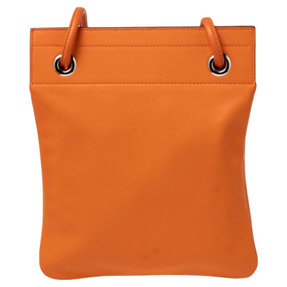 This Hermes Aline bag is made from orange leather. It features a leather shoulder strap and silver-tone hardware. The bag opens to a spacious interior for storing all your daily essentials.

Includes: Original Dustbag, Original Box, Hermes Eraser
