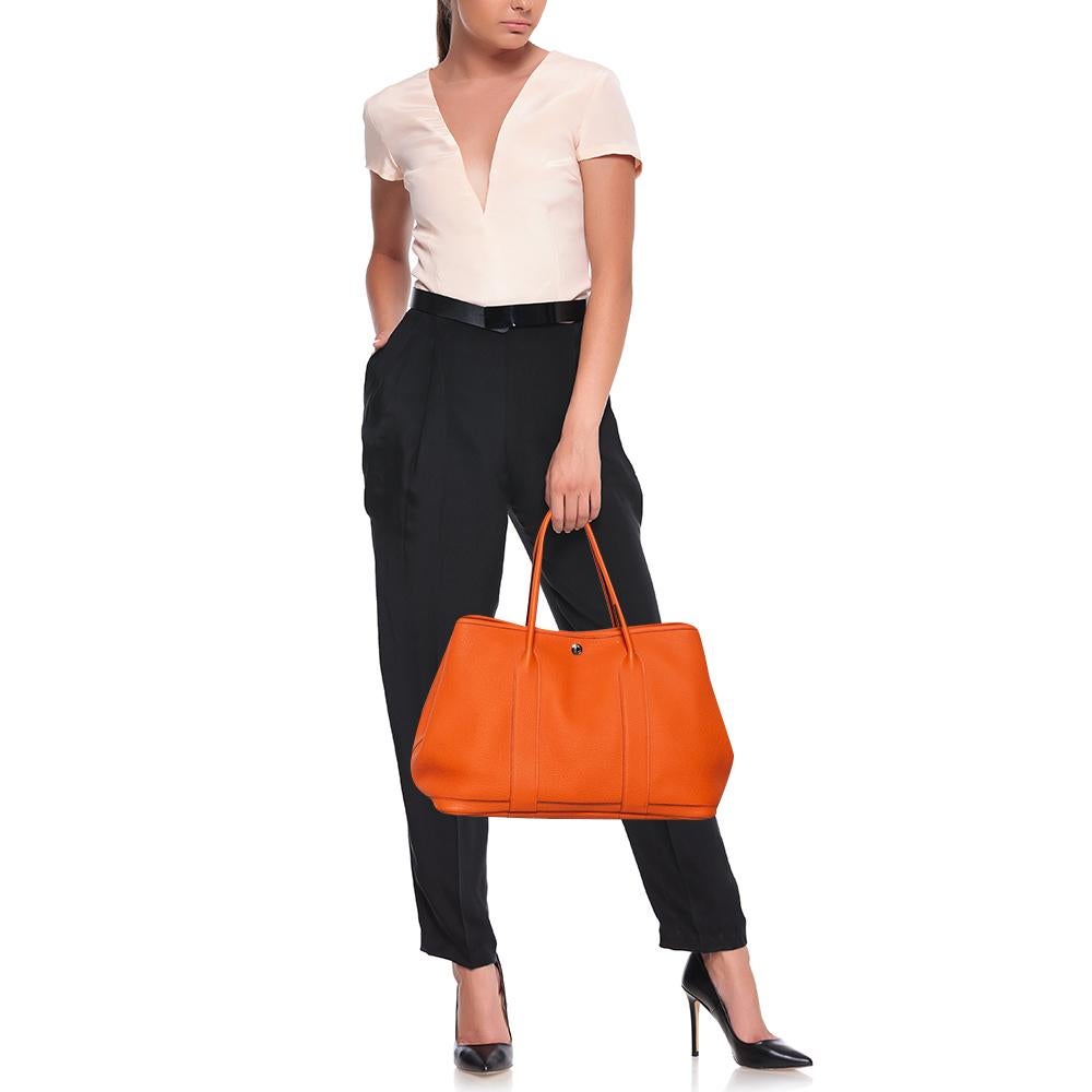 Look every part the royal diva you are by swinging this exquisite Garden Party tote from Hermes. This beauty has been meticulously crafted from leather and equipped with two top handles for you to parade it. Its canvas and leather interior is