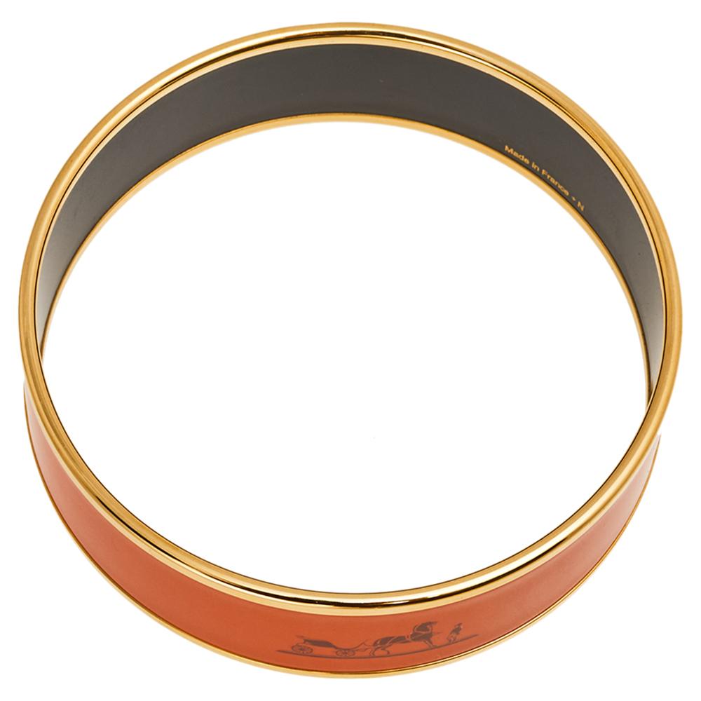 This bangle bracelet from Hermès is simply amazing and radiates elegance and grace! It comes crafted from gold-plated metal and orange enamel and features the brand's iconic logo ensconced in the center. It will help you outline a chic look and will