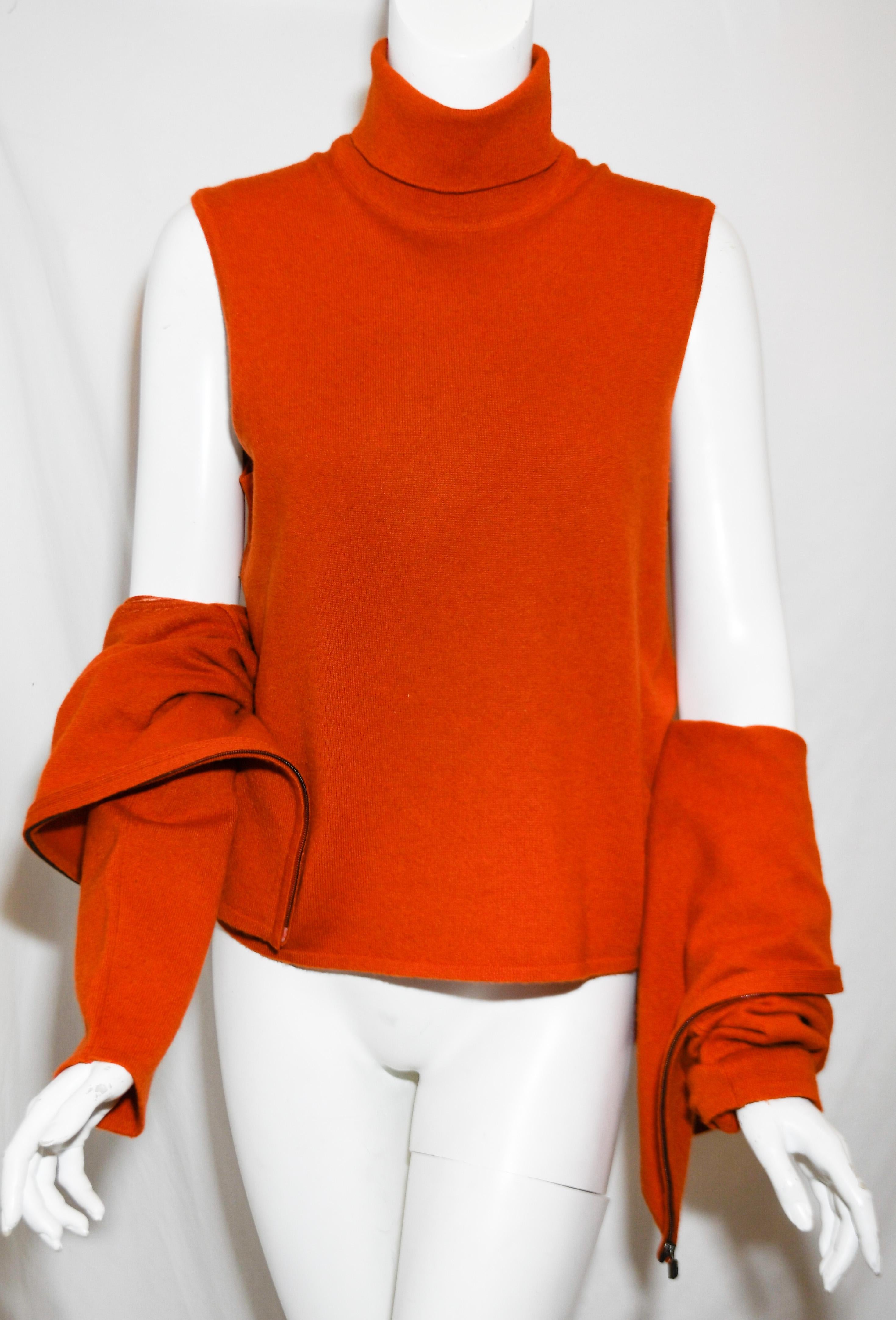 Hermes Orange cashmere twin sweater set includes a turtleneck sleeveless top and a long sleeve cardigan.  This cardigan contains a front zipper Hermes logo Kelly lock pull.   This twin set is in excellent condition.  The set is unlined.  Made in