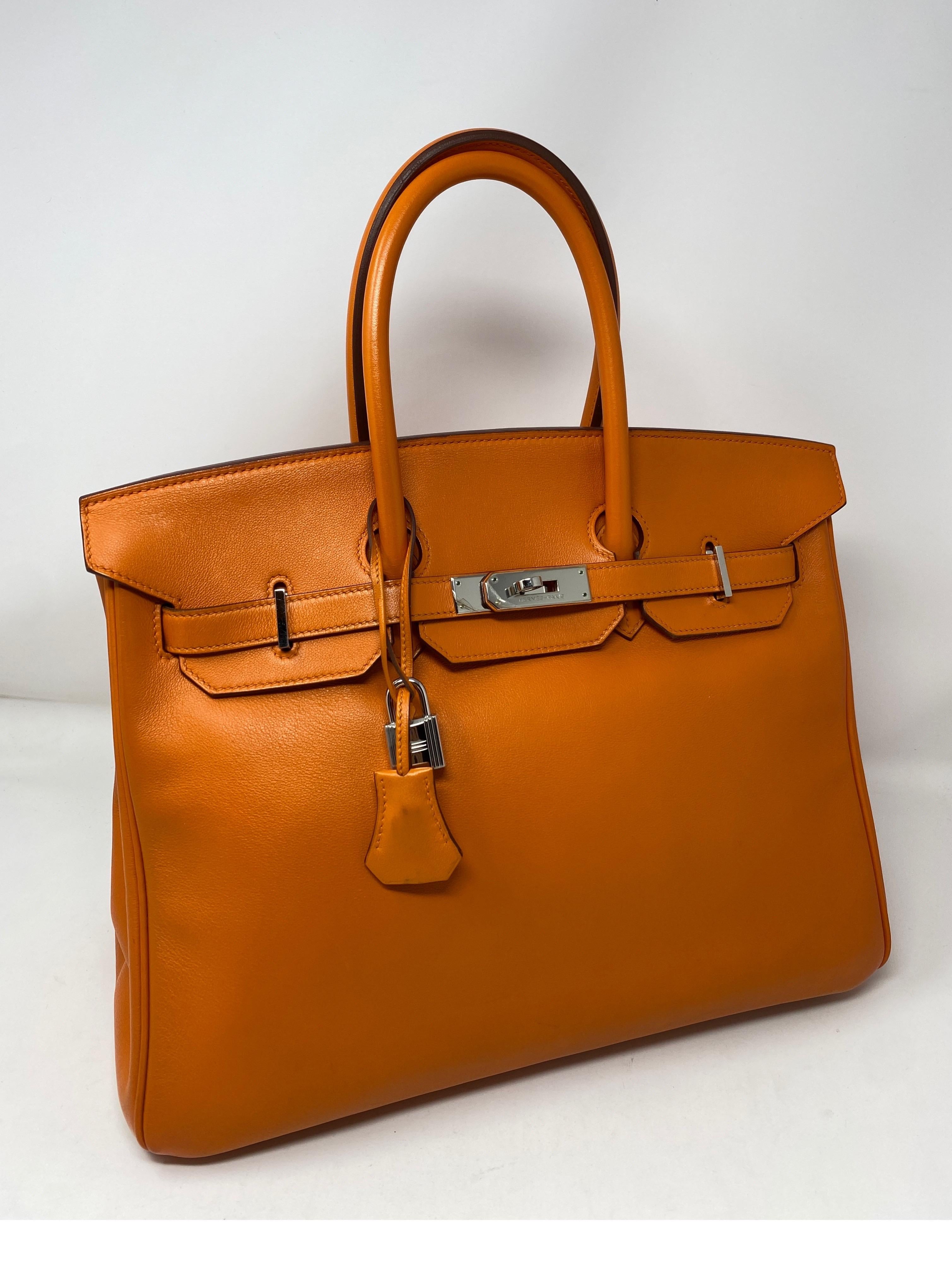 Hermes Orange Birkin 35 Bag. Swift leather. Palladium hardware. Good condition. N square stamp. From 2010. Hermes Orange color. Highly coveted. Includes lock, keys, clochette and dust cover. Invest in the best. Guaranteed authentic. 