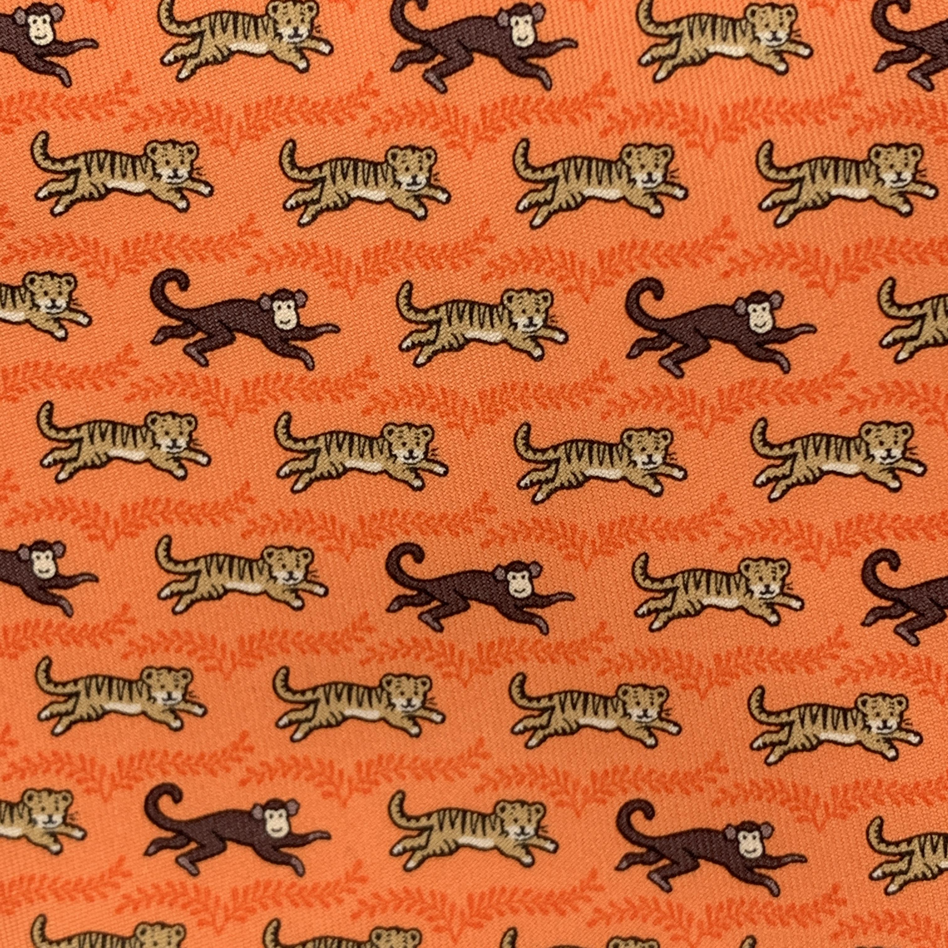 HERMES necktie comes in orange silk twill with all over tigers and monkeys print. Made in France.

New with tag.

Width: 3.75 in. 