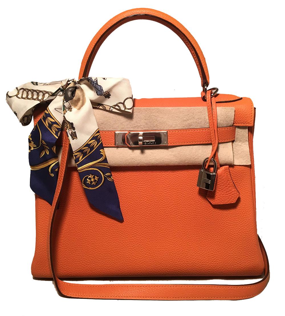 Hermes Orange Togo Leather PHW 28cm Kelly Bag in very good condition. Fabulous signature Hermes orange togo leather exterior trimmed with silver palladium hardware. Classic double strap twist closure opens to a matching orange leather interior that