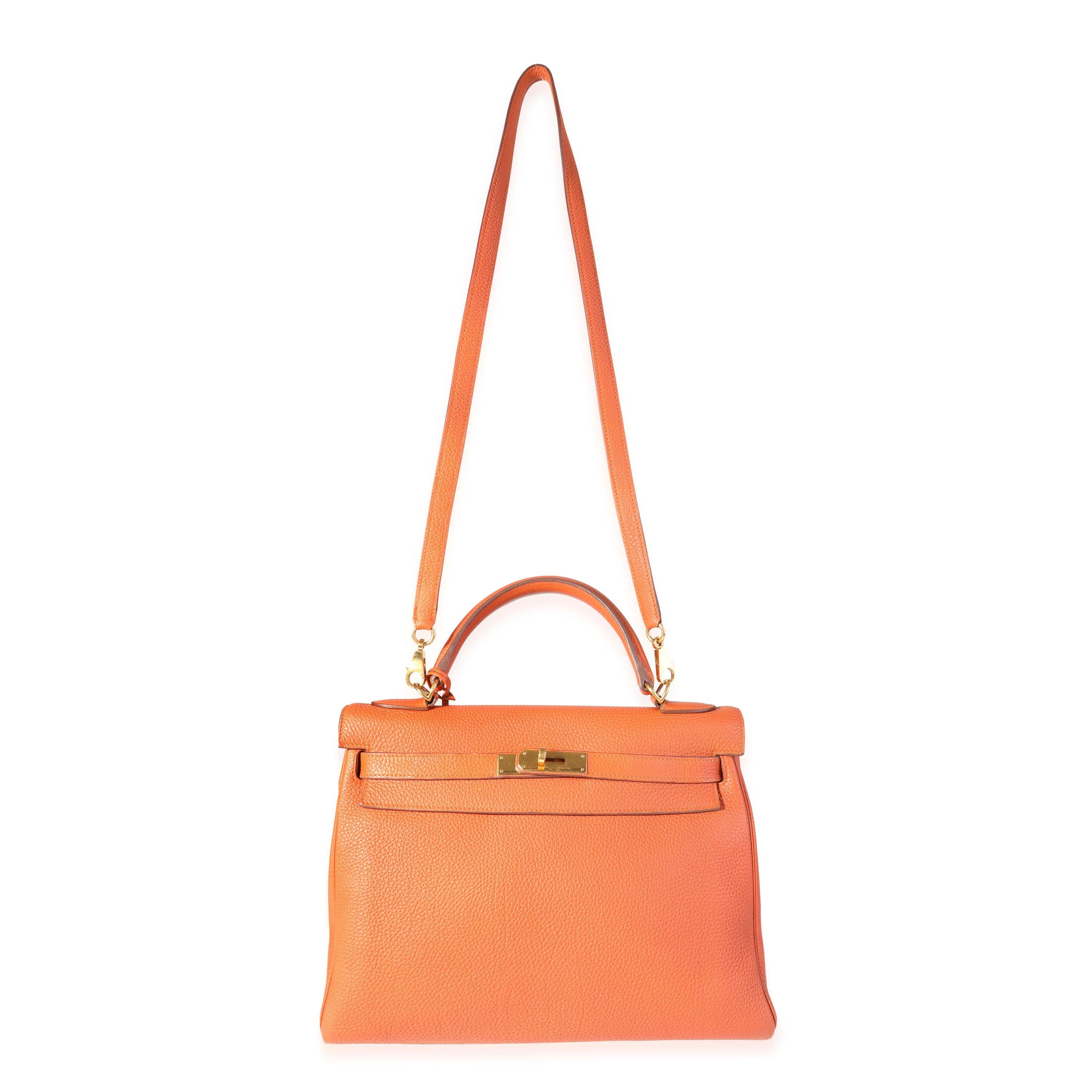 Listing Title: Hermès Orange Togo Retourne Kelly 32 GHW
SKU: 118574
Condition: Pre-owned (3000)
Handbag Condition: Very Good
Condition Comments: Very Good Condition. Light scuffing to corners. Discoloration and wear to handle. Scratching and