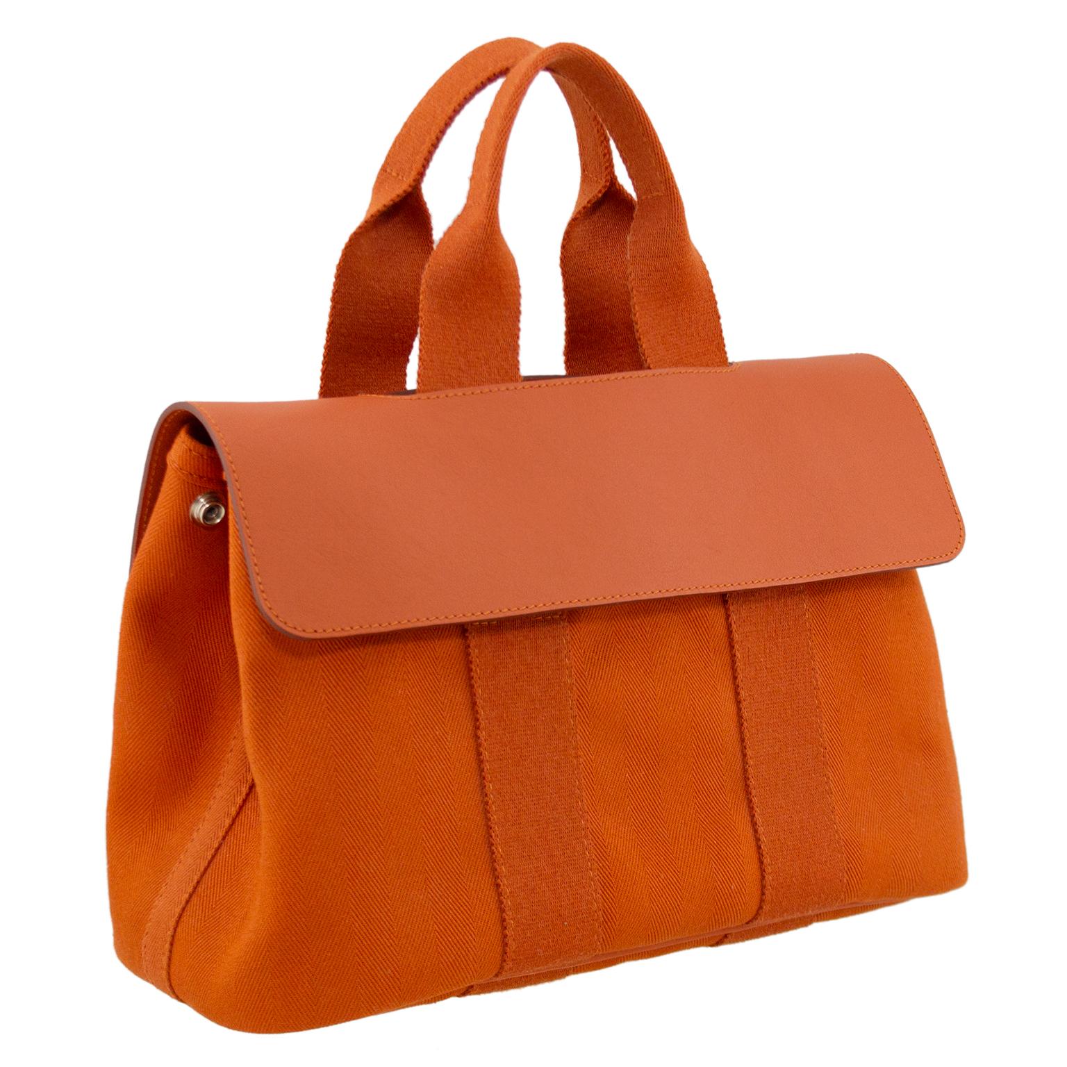 Embodying the Hermès essence, the Valparaiso PM handbag is handcrafted with simple lines and minimalistic construction. In a brick orange hue, this everlasting piece features a toile body and rounded top handles with a calf leather fold over