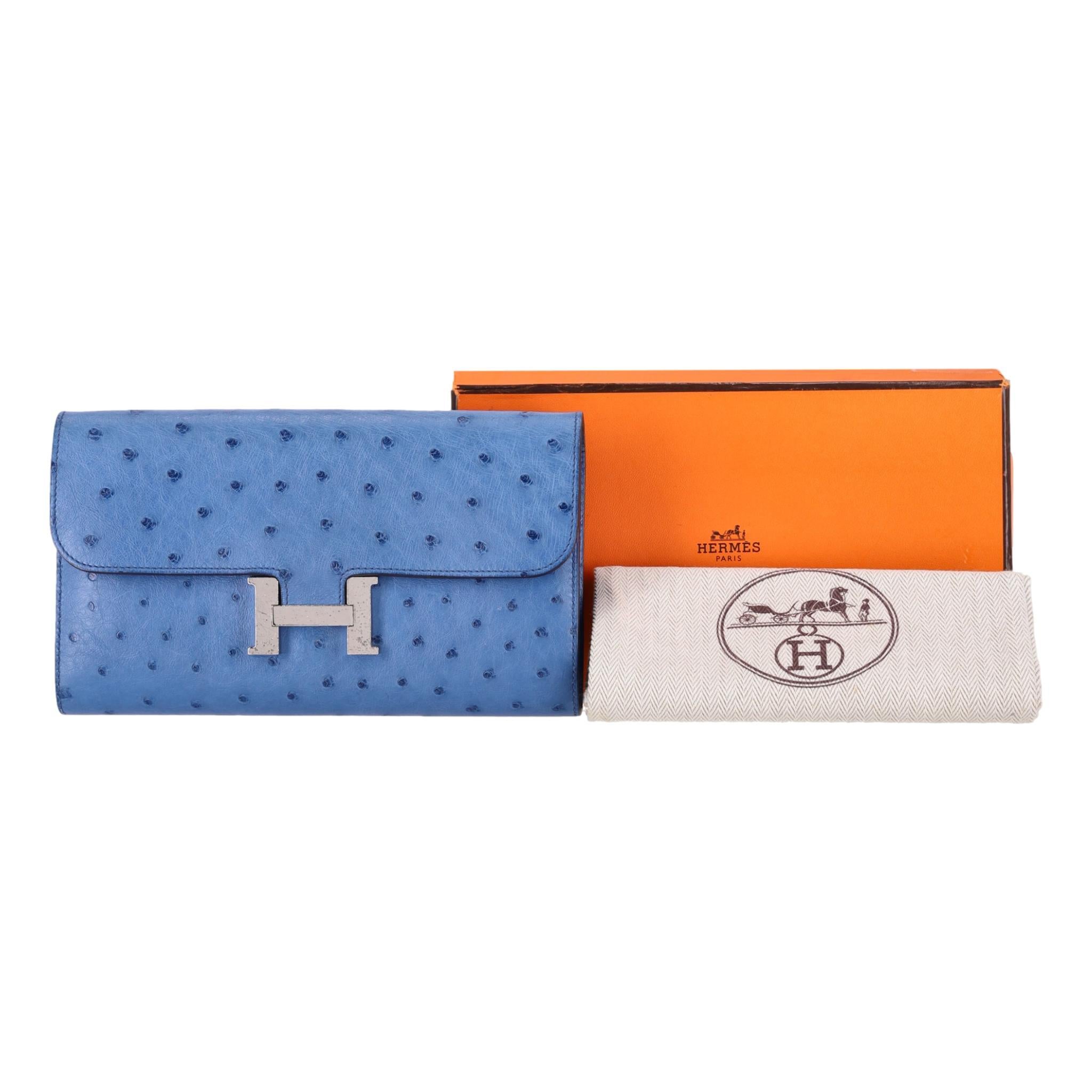 Hermes Ostrich Skin Constance Long Wallet

Sapphire blue Ostrich skin with large 'H' closure in palladium hardware.

Front flap opens to tonal, partitioned interior with card slots and a zipper pocket.

Can be used as a clutch bag.

Date stamp C -