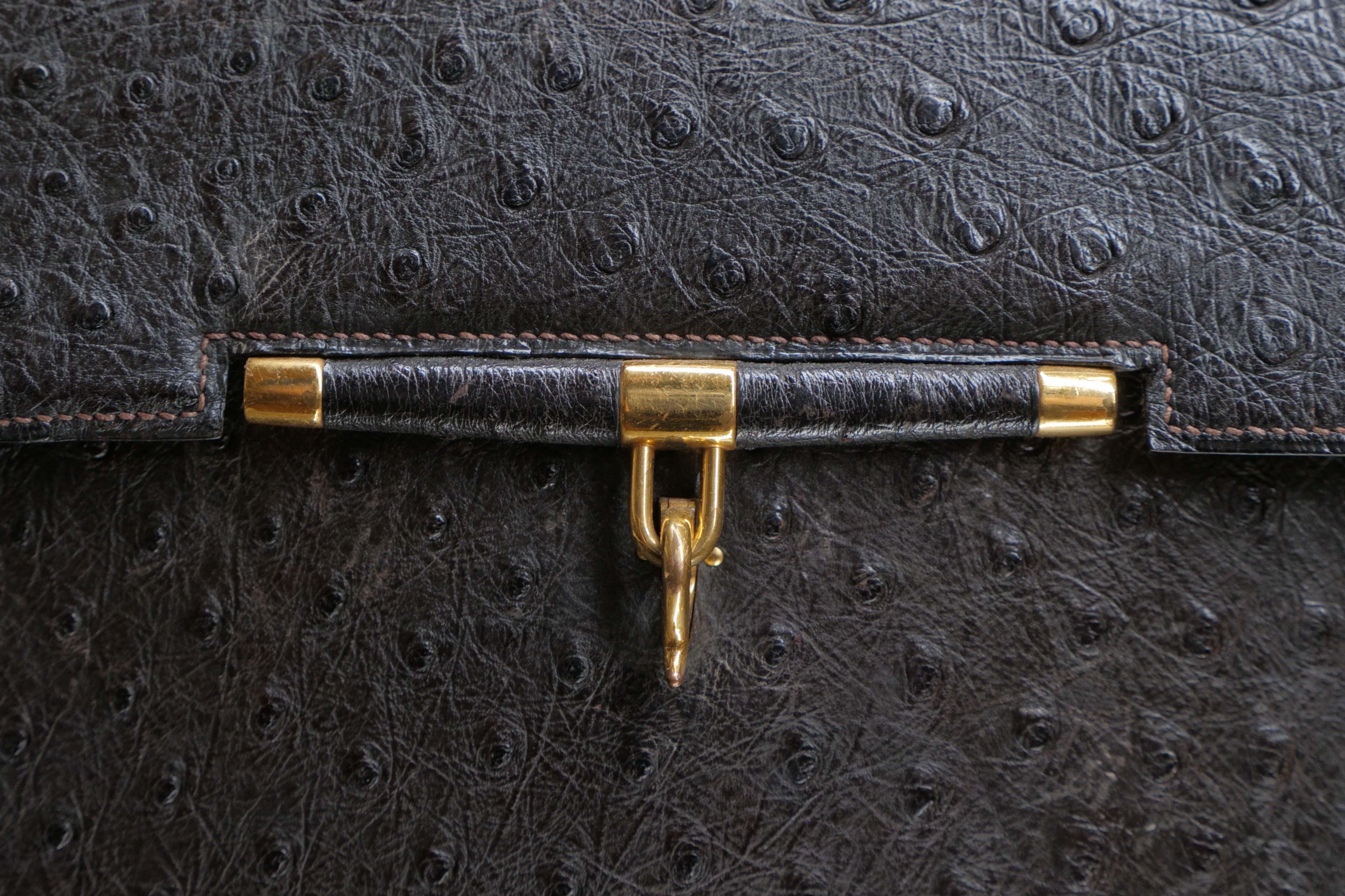 Dark Brown, Ostrich, Hermes Flap Handle Bag w/ Gold Hardware and Hook Closure.