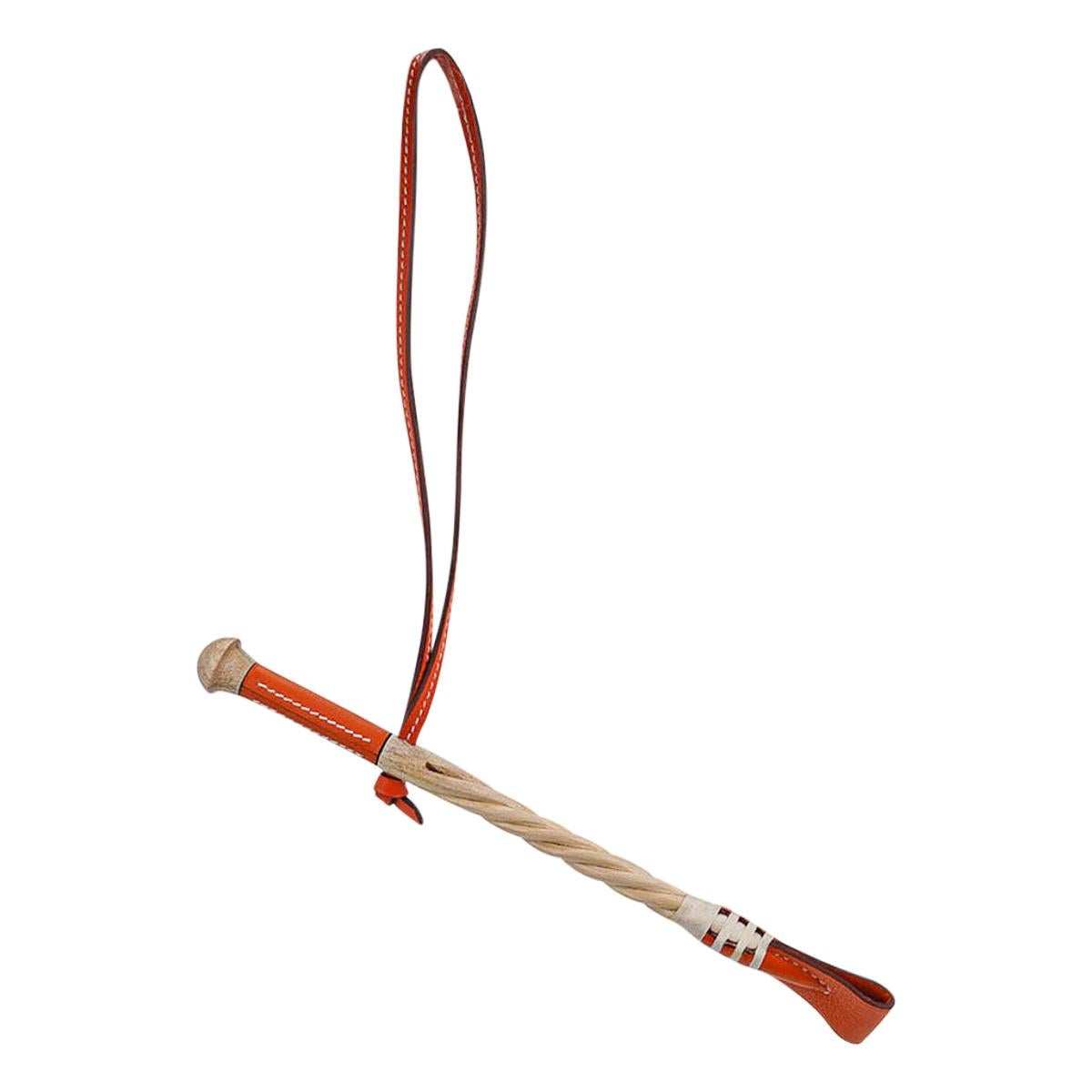 Mightychic offers a rare Hermes Paddock Cravache riding crop bag charm featured in Orange Vache Hunter leather.
Beautifully detailed hackberry wood.
Stamped Hermes Paris Made in France on the leather.
Charming and playful she easily adorns a myriad