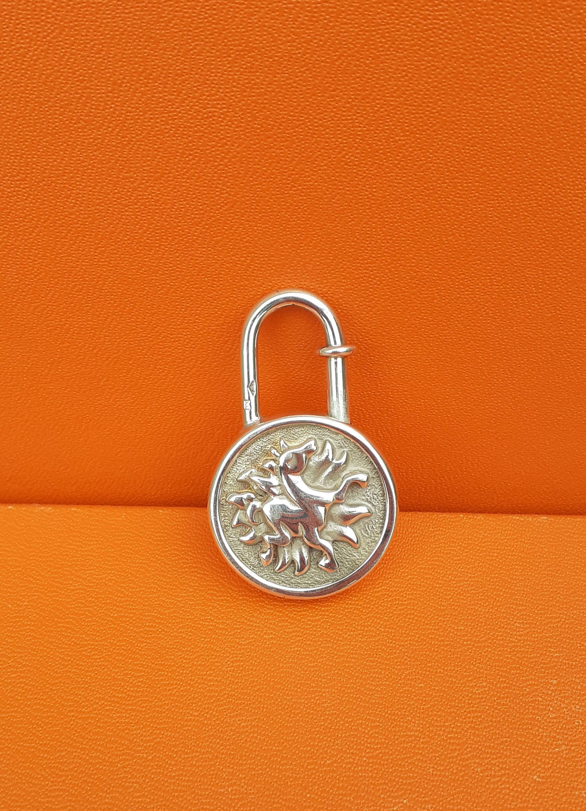 Collectible Authentic Hermès Padlock

Can be used as bag Charm

Round shape with a sun and a horse in the middle

Special Edition for the Hermès year of the sun 1994

Made of silver

Colorway: silvery

