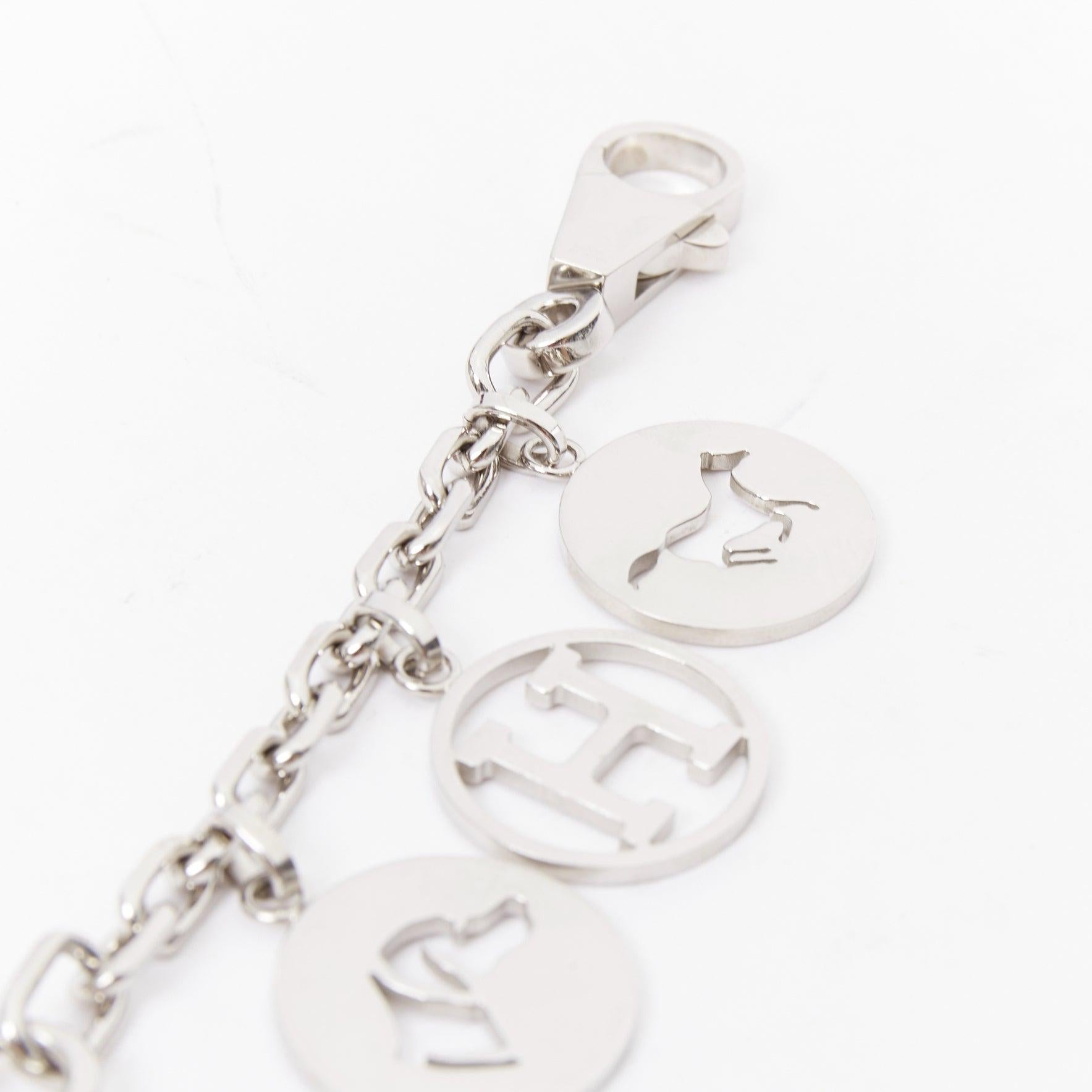 HERMES Palladium Breloque Olga Cadena lock H logo horse dog coin bag charm chain
Reference: TGAS/E00682
Brand: Hermes
Model: Breloque Olga Cadena
Material: Metal
Color: Silver
Pattern: Solid
Closure: Lobster Clasp
Extra Details: The charms are