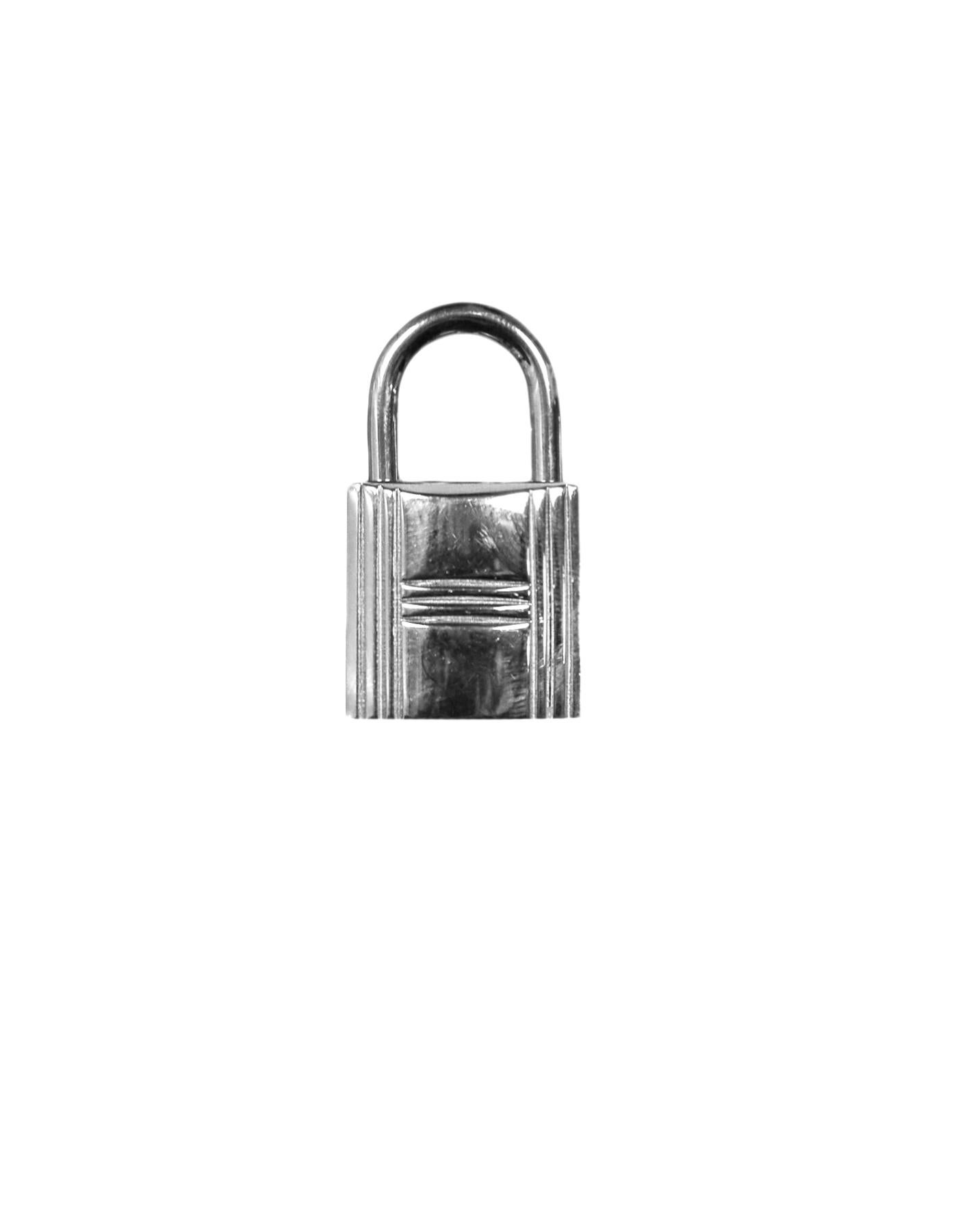 Hermes Palladium Cadena Lock and Key Set.  Marked number 100

Color: Silver
Materials: Palladium
Overall Condition: Very good pre-owned condition, minor surface scuffs on the lock
Includes: Pouch

Lock Measurements:
0.75