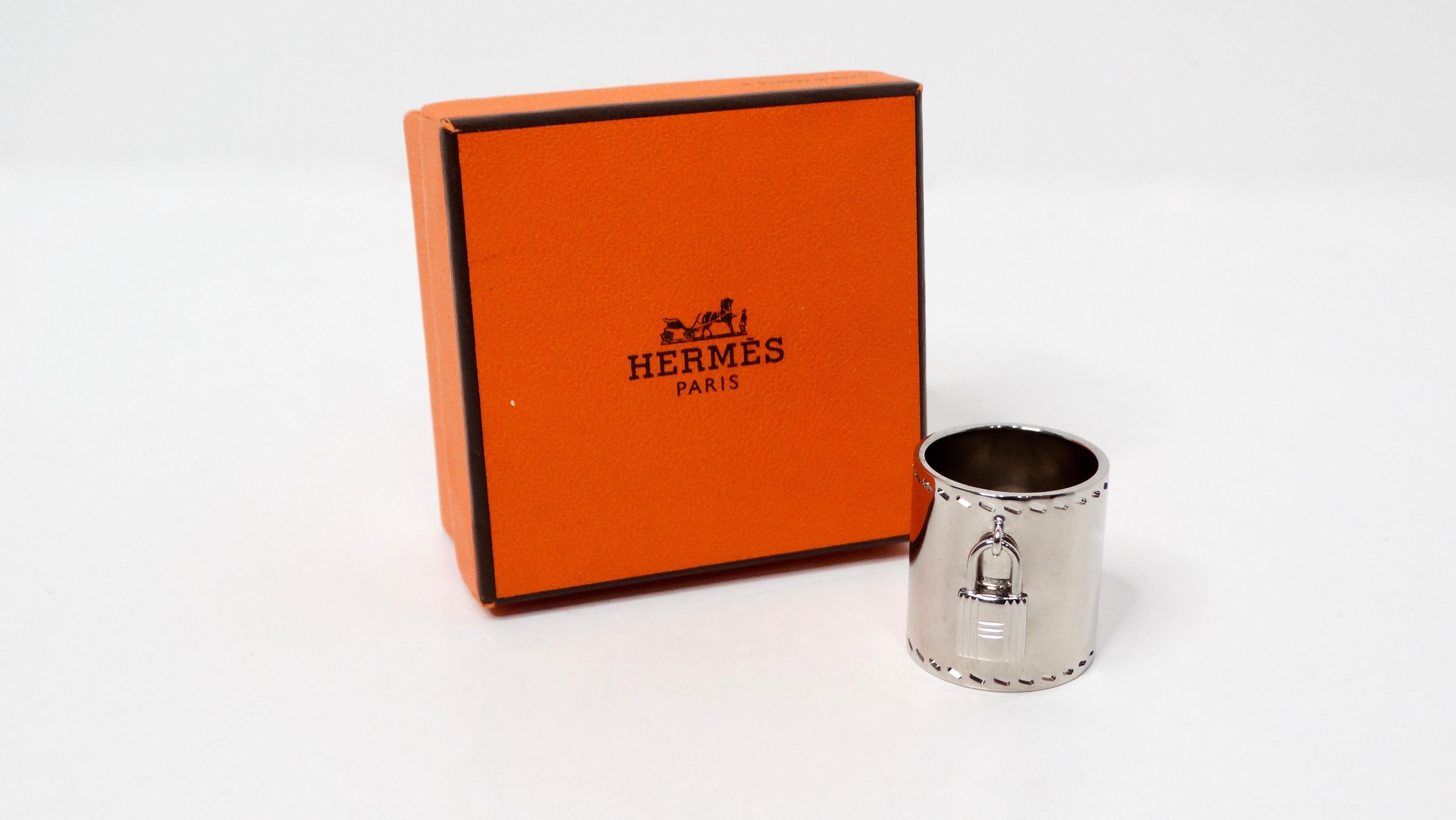 The Hermès Palladium Padlock Charm Scarf Ring is a stunning accessory that exudes elegance and sophistication. Crafted from palladium, this sleek silver-toned ring features a beautifully detailed padlock charm, paying homage to the iconic Hermès