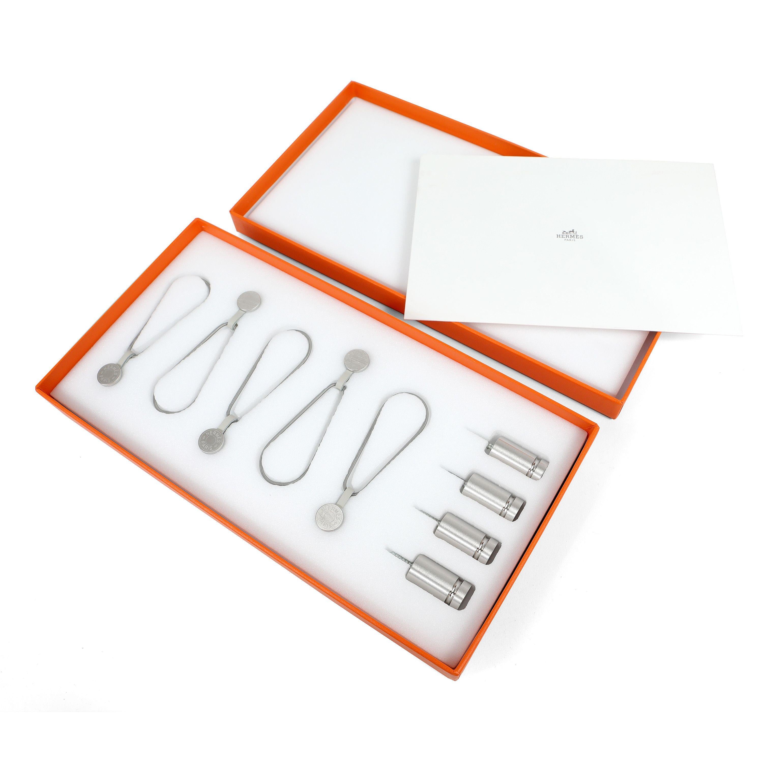 This authentic Hermès Scarf Display System is brand new in the box.  Designed specifically for silk scarves.  Set includes magnets, screws and cables.  Box included.

PBF 13983
