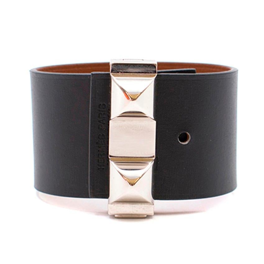 Hermes Leather Bangle

- Black leather
- Tan interior leather
- Palladium hardware
- Double stud detail to the front with press-button fastening
- Hermes, Made in France, sizing and serial code embossed on the leather
- 2 holes to adjust