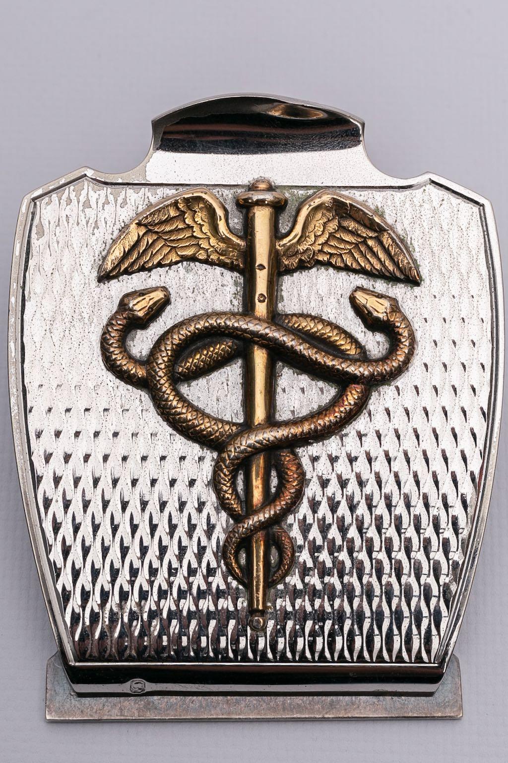 Hermes -Paperweight in solid silver representing a caduceus.

Additional information: 
Dimensions: Length: 10 cm (3.93