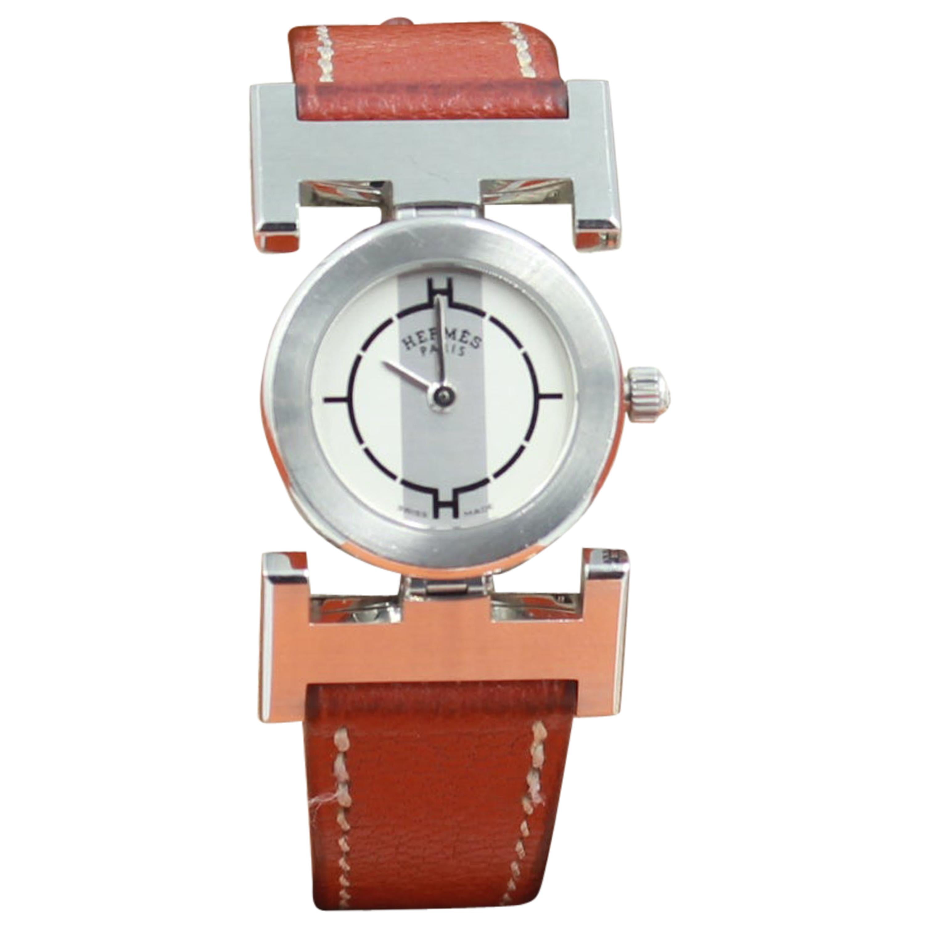 Hermès Paprika watch with a brown leather strap.