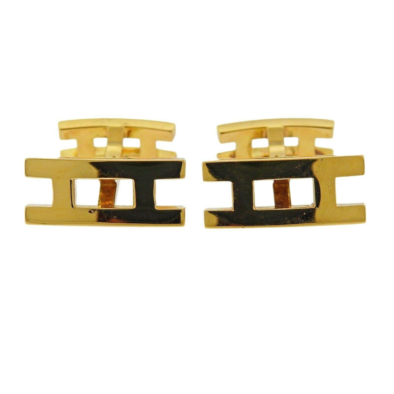 18k yellow gold H logo cufflinks by Hermes. Cufflinks measure 18mm x 8mm. Weight is 10.6 grams. Marked: French mark, Hermes, Au750, 89521.