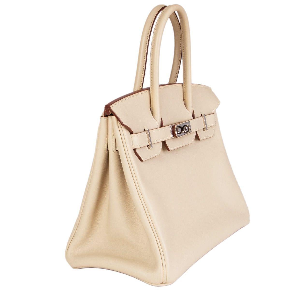 Hermes 'Birkin 30' in Parchemin (cream) Veau Swift leather. Lined with an open pocket against the front and a zipper pocket against the back. Has been carried and is in virtually new condition except for a tiny scratch on one handle. Comes with