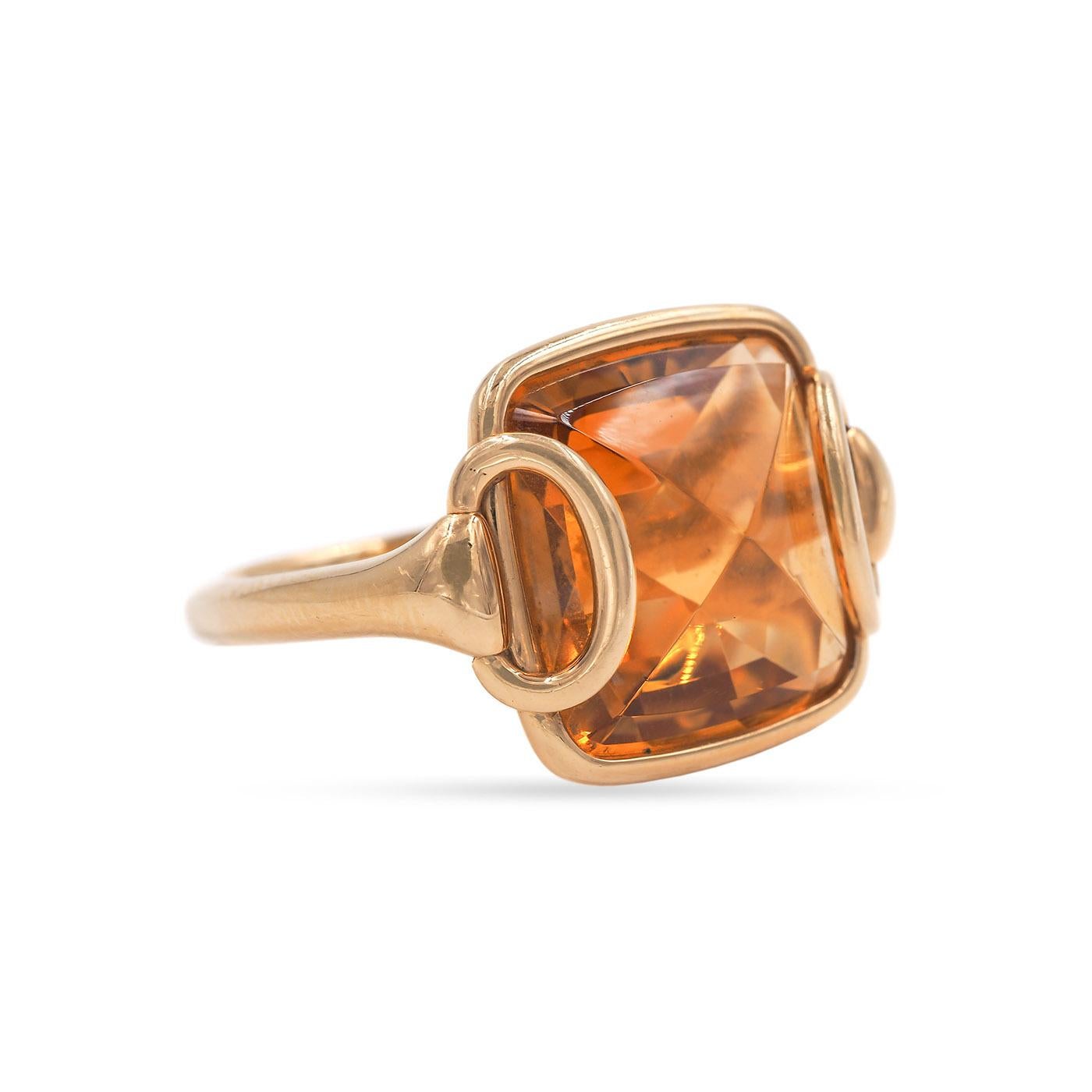 Contemporary 15 Carat Citrine Ring by Hermès composed of 18k yellow gold. The citrine is a double pyramidal cabochon, with horse-bit shoulder details. Weighs 14.5 grams.
Stamped 'HÈRMES', French hallmarks.