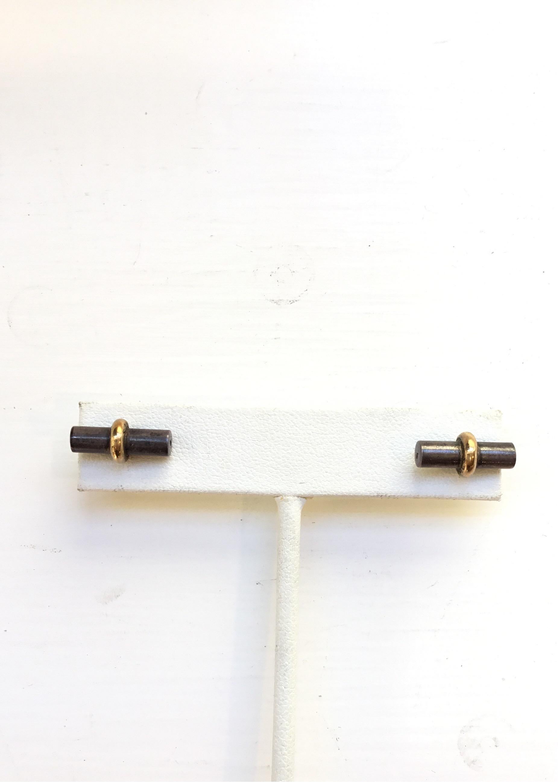 Hermes bar stud pierced earrings with squeeze-insert backs. Earrings are composed of 18k gold and sterling silver. 
