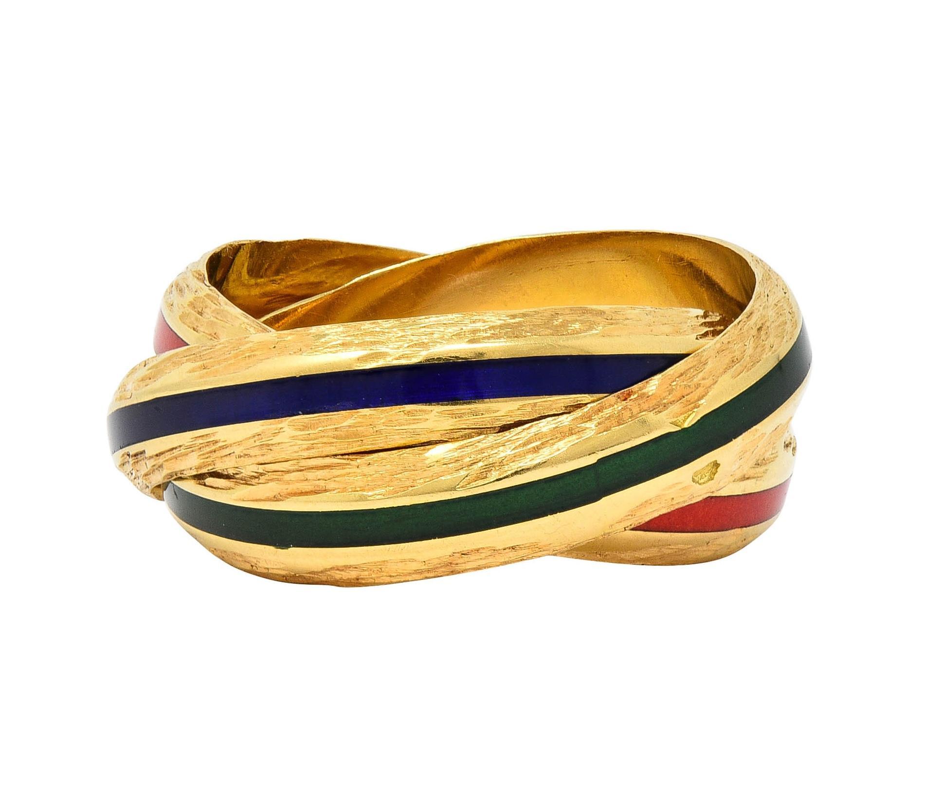 Designed as three interlocking gold bands each centering an enamel stripe
Transparent medium blue, red, and green in color - minimal loss
Each flanked north to south by textured edges 
Stamped with French hallmarks for 18 karat gold
Fully signed for