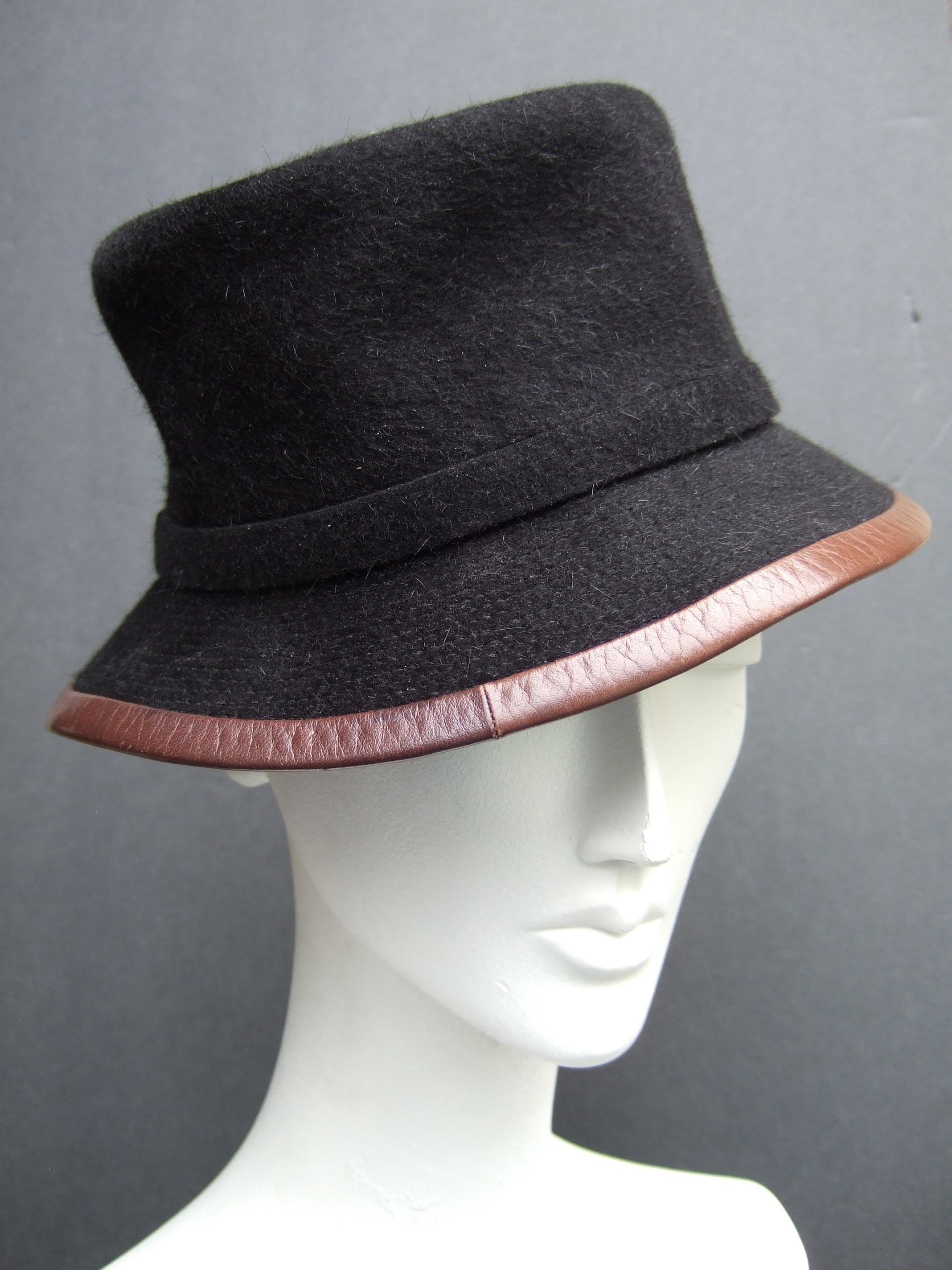 Hermes Paris Black felt wool leather trim hat labeled Motsch Chapeaux Pour Hermes Size 56 Small 
The stylish black felt wool hat is juxtaposed with brown leather border trim 

Makes a chic timeless accessory 
Labeled: Motsch Chapeaux Pour Hermes