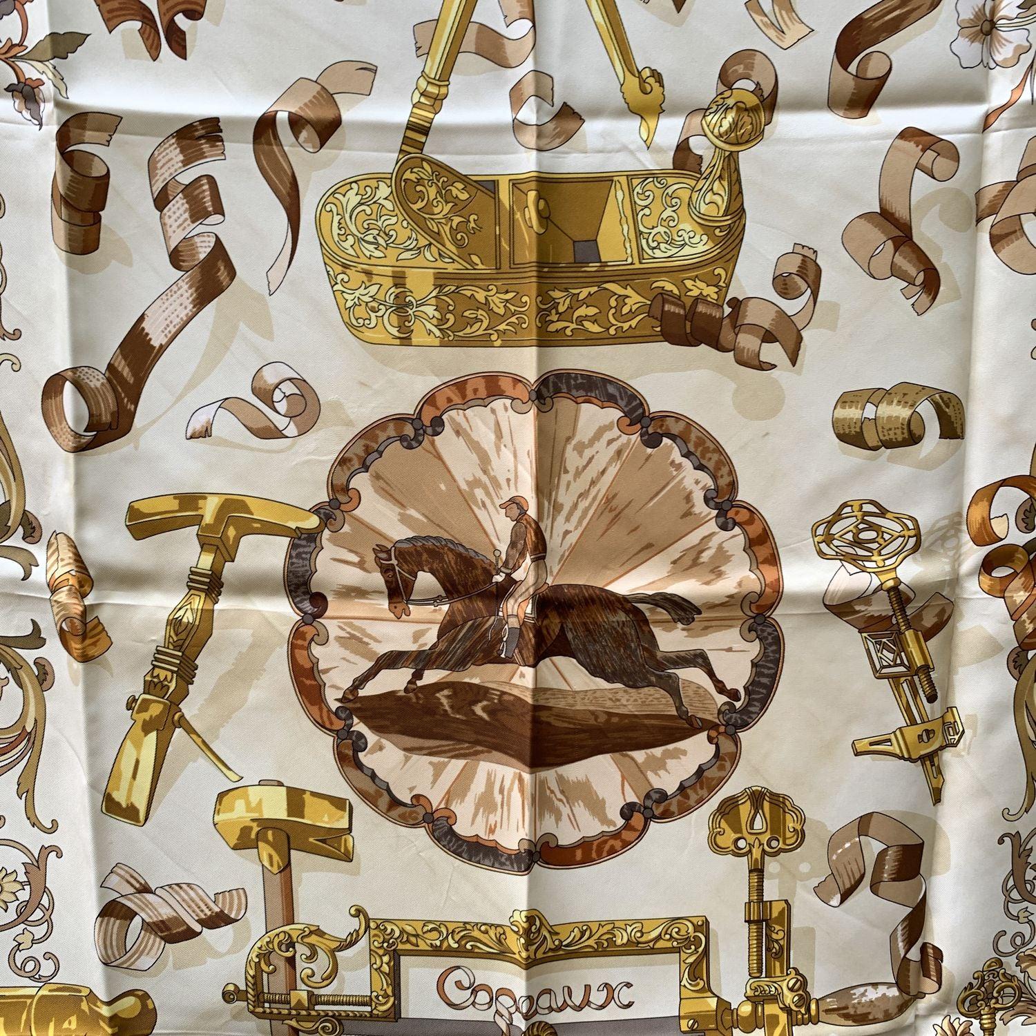 HERMES scarf 'Copeaux' by Caty Latham and originally issued in 1998. Equestrian design. Blue borders. 100% silk, hand rolled hem, made in France. Composition tag still attached. Measurements: 35 x 35 inches - 88,8 x 88, 8 cm. 'HERMES Paris' printed
