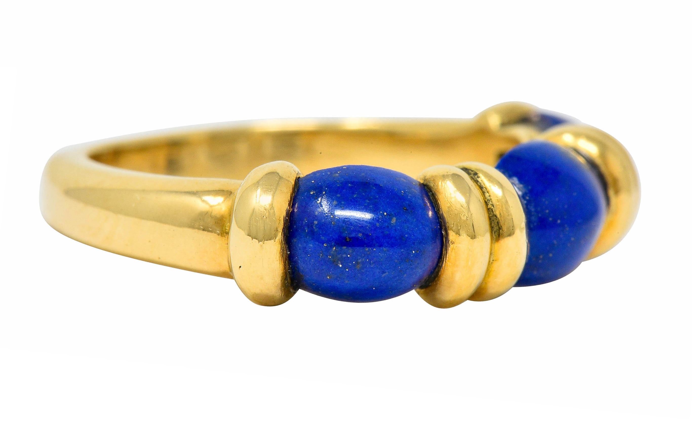 Band style ring centering three oval lapis cabochon measuring approximately 6.4 x 5.5 mm

Well-matched with uniform ultramarine color with some flecks of pyrite, especially on center stone

Each stone alternates with deeply ribbed gold

Fully signed
