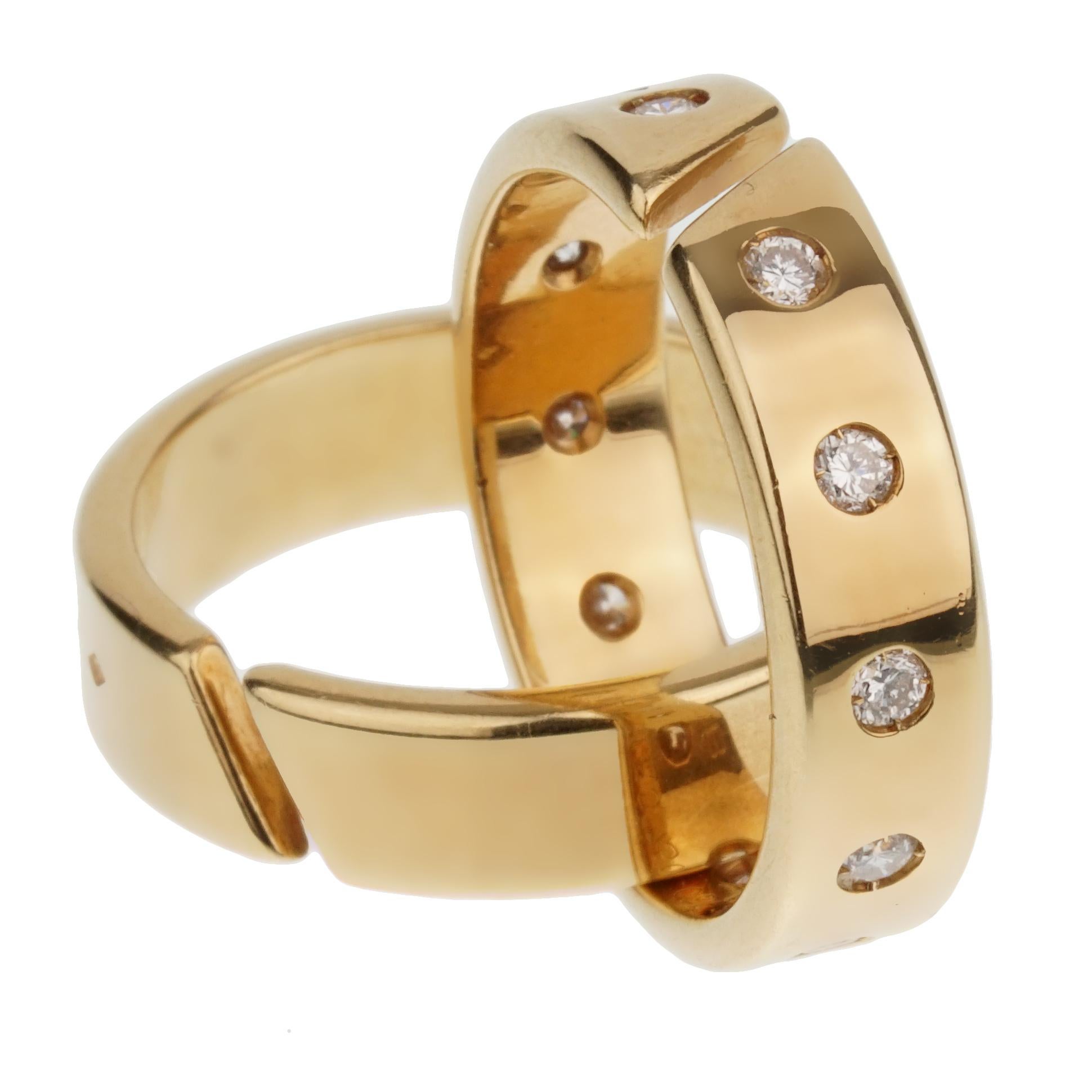 A fabulous Hermes rolling ring showcasing 1 band set with original Hermes round brilliant cut diamonds intertwined with a plain band. Each band is fully hallmarked the rings measures a size 51 eu.