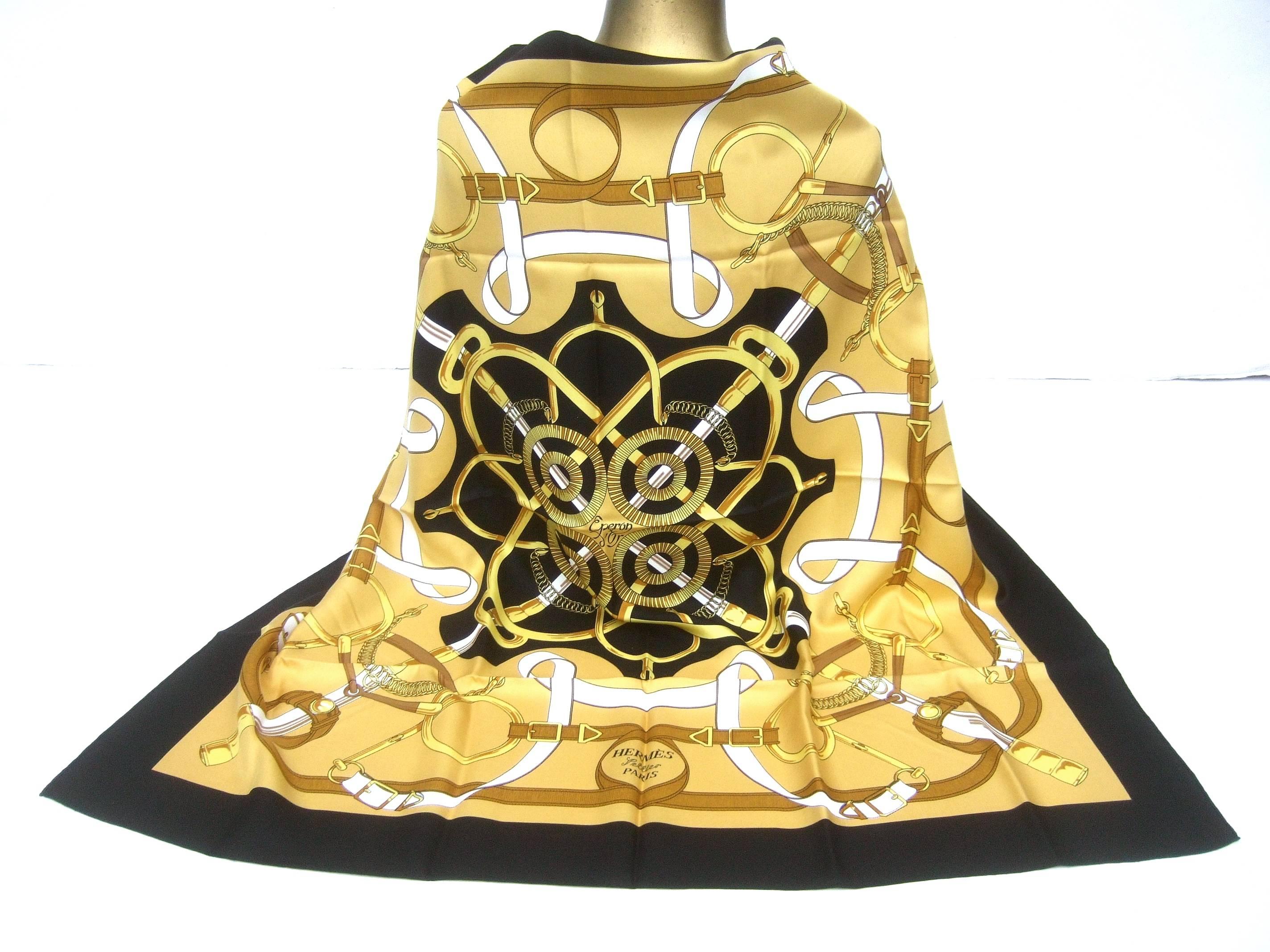Hermes Paris elegant equestrian bridal theme scarf c 1990s
The luxurious silk hand rolled scarf is illustrated with a collection 
of sinuous golden bridals set against a stark black center 
background with a matching black border 

The sumptuous