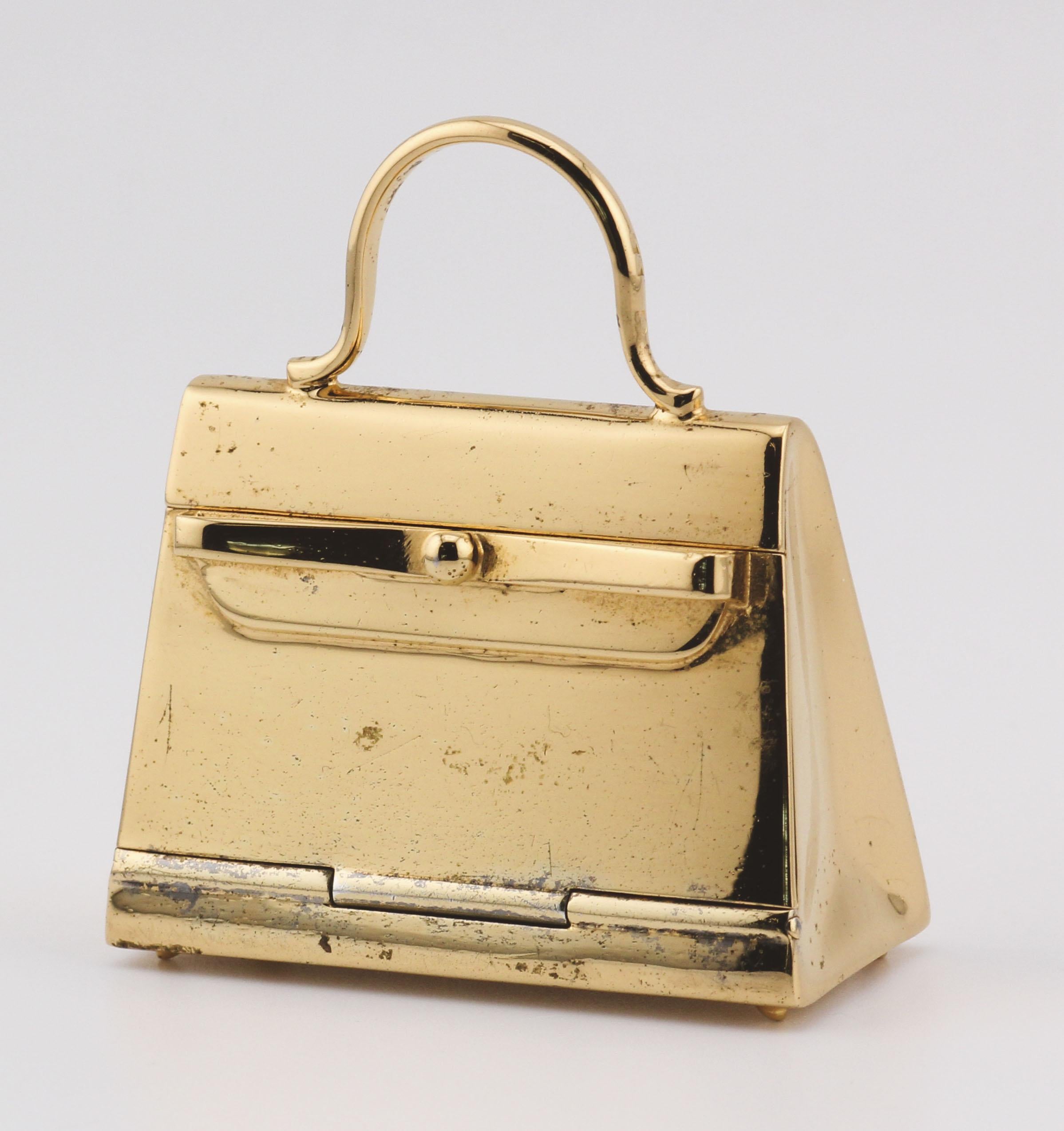 Embrace the epitome of luxury and craftsmanship with this exquisite Hermes Paris Gold Plated Sterling Silver Kelly Bag Pill Box Charm Pendant. Meticulously crafted, this pendant is a testament to Hermes' legacy of creating exceptional pieces that