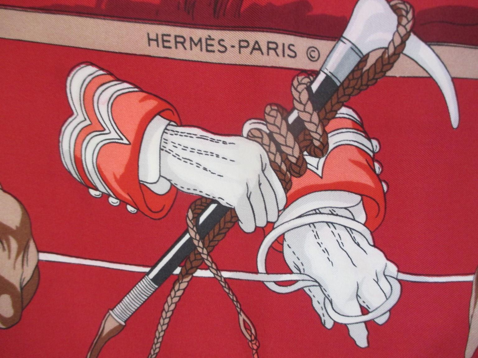 A vintage silk scarf by Hermes styled with classic hunting scene and hound border, on a red background.
This Hermès is a true collector's scarf in collector's condition, one to own to wear, show or frame. 

Measurements: Length 77cm x Width 80cm
