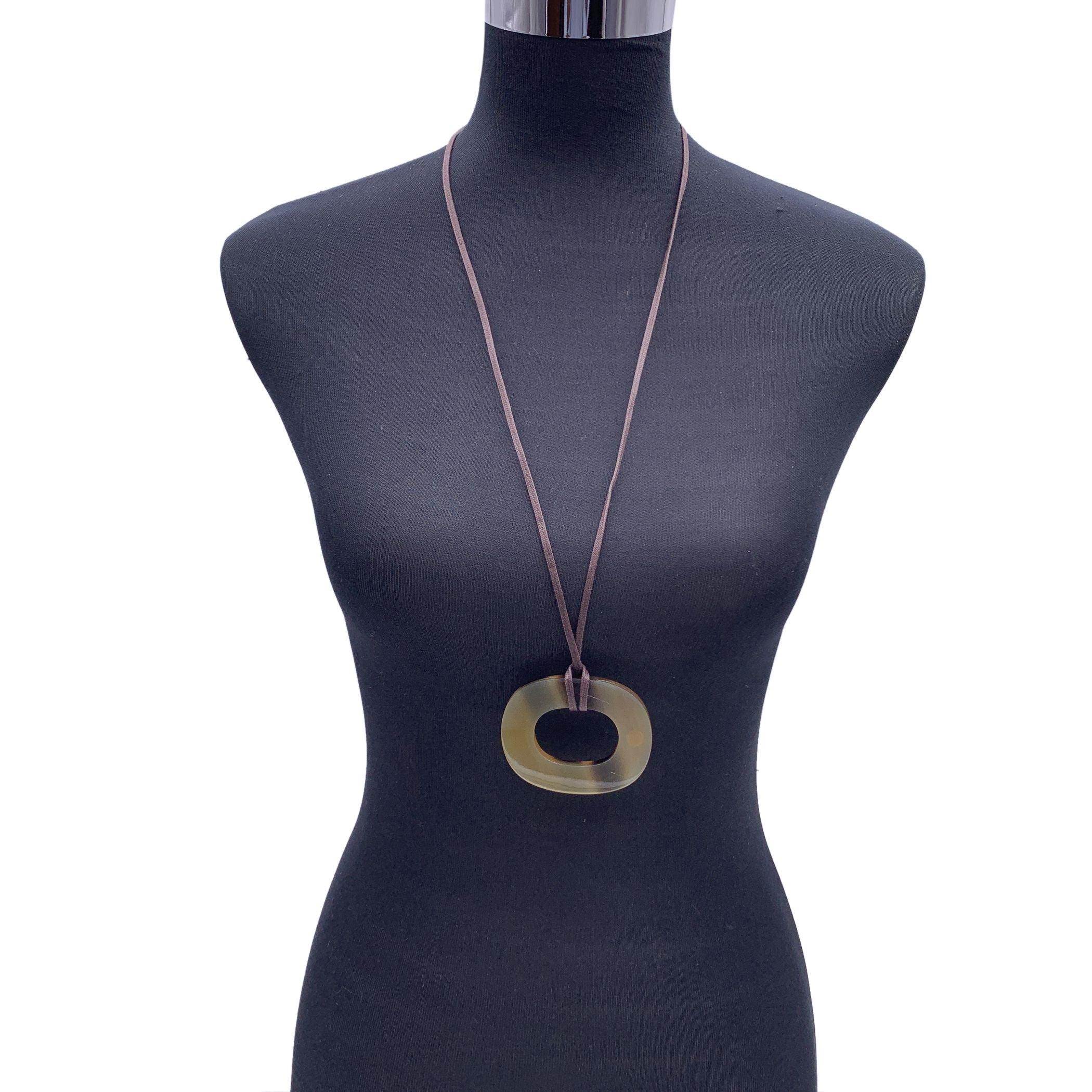 Beautiful pendant necklace 'Isthme' by Hermes. Elegant pendant in buffalo horn with adjustable waxed cotton cord. 'Hermes'engraved on the border. Total length of the strap: 29.5 inches - 72 cm. Pendant height: 3.25 inches - 8.5 cm. Pendant width: