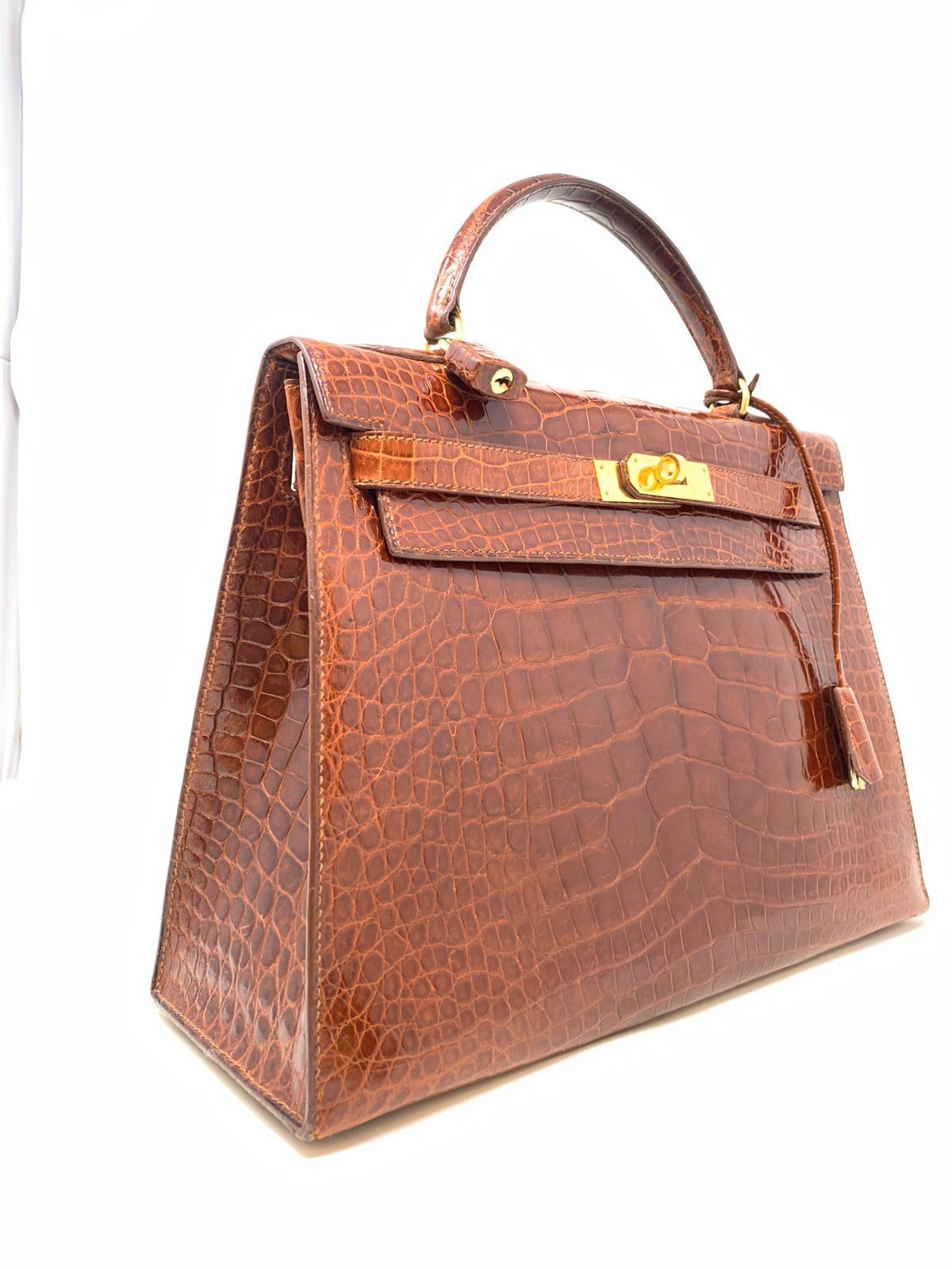 Hermes iconic bag, is in good condition with small signs of wear inside suede pocket and zip pocket : Sac Kelly 32 Sellier shiny alligator miel color. 
Year of production 1992
Hdw Gold
Good condition complete with shoulder strap.
