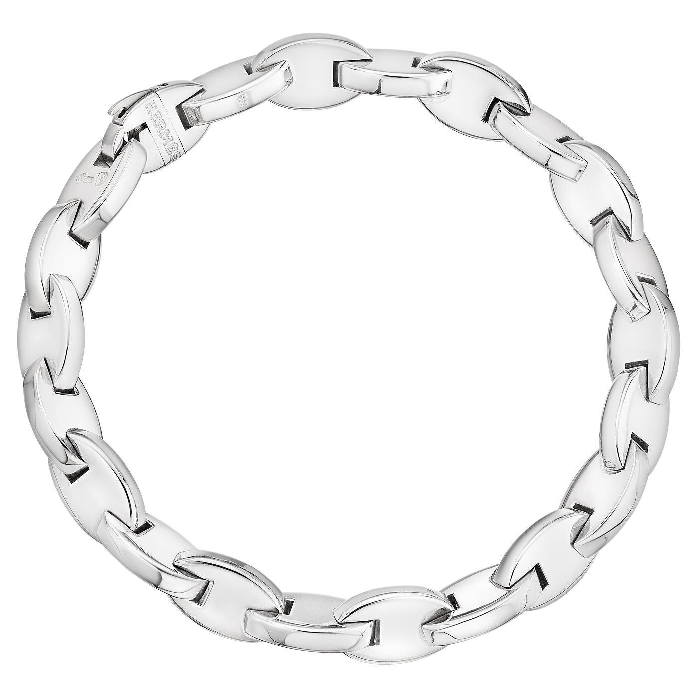Hermes Paris modernist sleek oval link 18 karat white gold bracelet strongly stands alone or stacked with others but is always perfect worn everyday and everywhere.  Signed Hermes with serial number 60250.  Circa 1980-90.  7 1/2