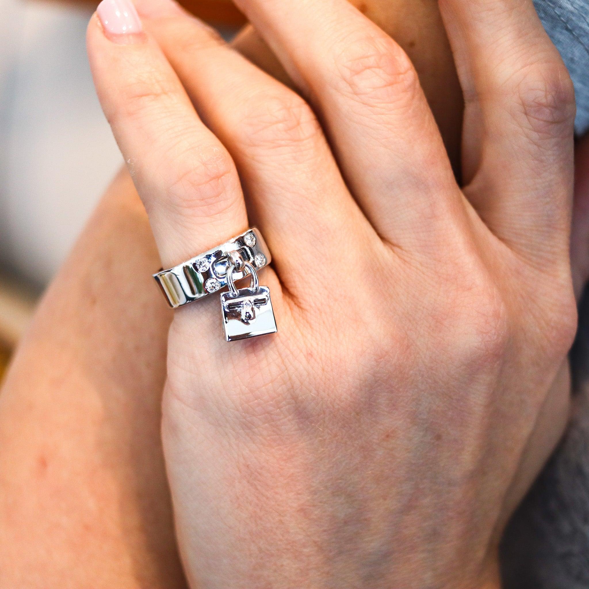 Kelly ring designed by Hermes.

This is the iconic Kelly-bag ring created in Paris France by the luxury house of Hermes. The ring was designed in the shape of a belt featuring a movable Hermes Kelly Bag and crafted in solid white gold of 18 karats