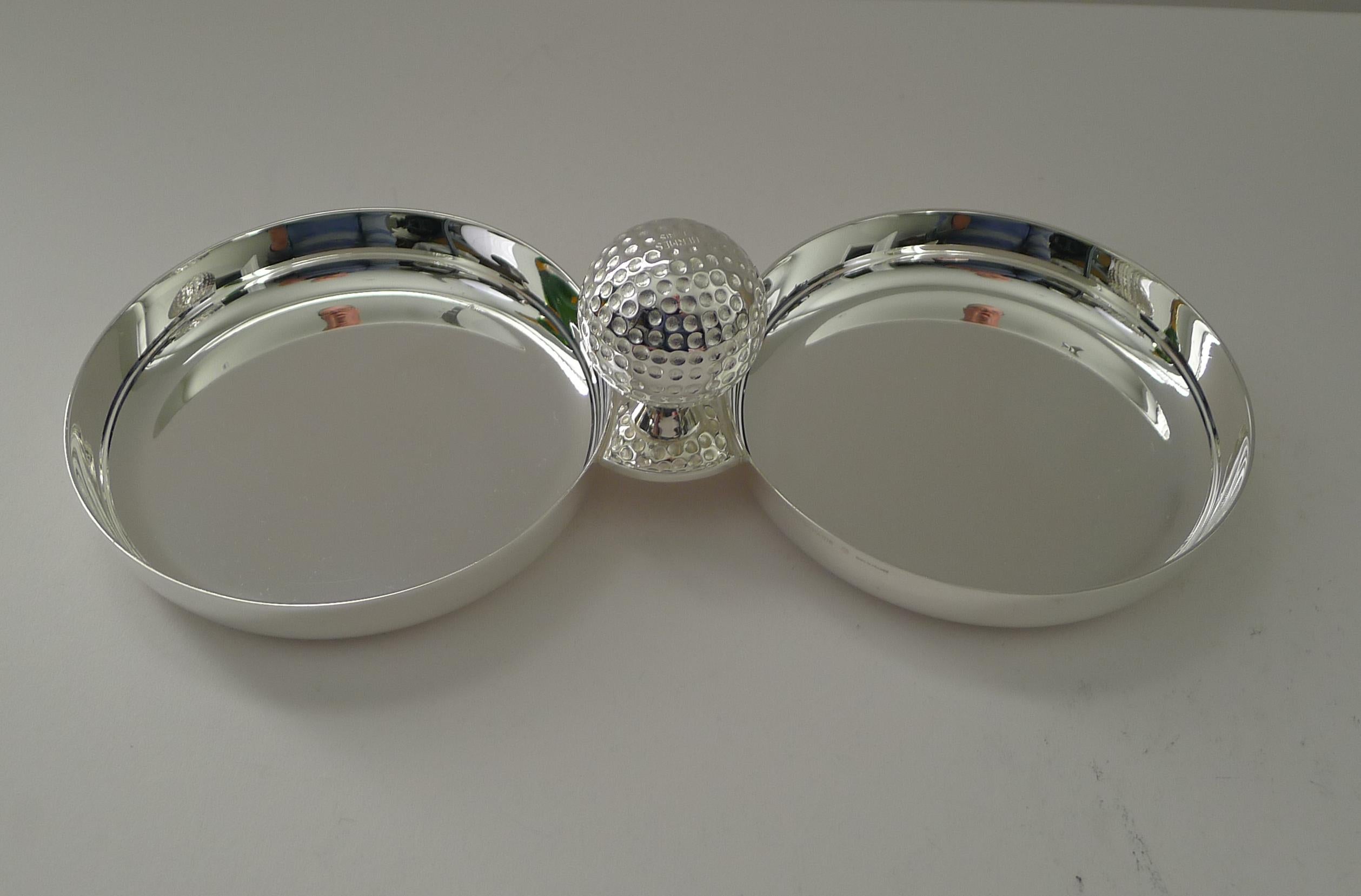 A handsome and rare pair of silver plated dishes or bowls jointed together with a decorative Golf ball handle in the centre.

Just back from our silversmith's workshop where it has been professionally cleaned and polished, restoring it to it's