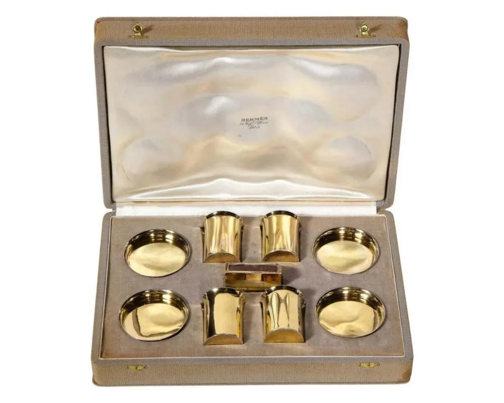 Hermes Paris & Ravinet d’Enfert, a rare French silver-gilt smoking set, circa 1930.

MARK OF Ravinet D’Enfert, PARIS, 20TH CENTURY, RETAILED BY HERMES

Very rare collectors piece.

Each piece plain, comprising:
Four circular ashtrays /