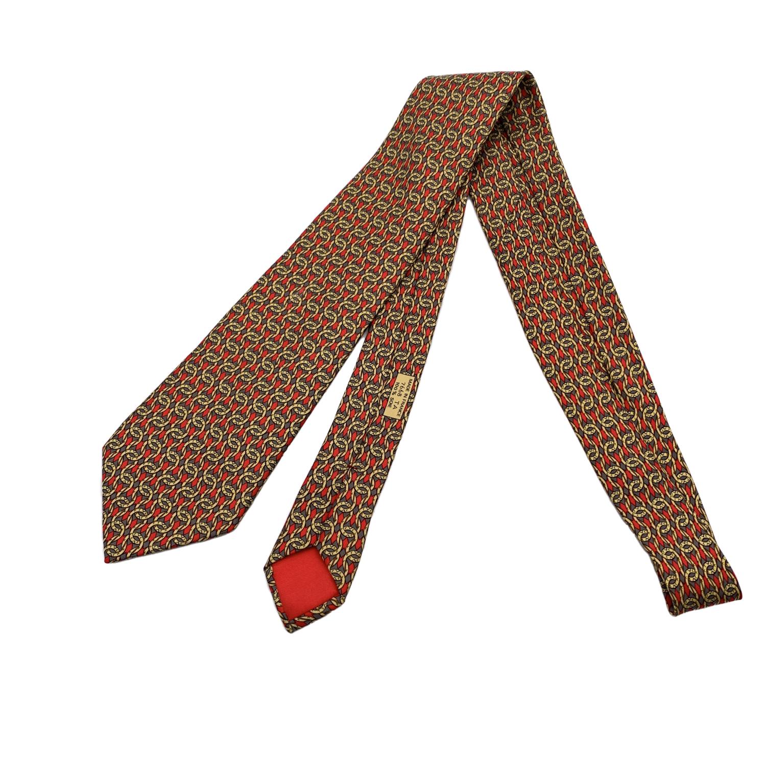 Elegant Hermes Neck Tie,7668 TA, with yellow chain link print on red background. Composition: 100% Silk. Hermes composition tag attached. 'HERMES Paris' with copyright symbol printed on the back. Made in France. Total length: 59 inches - 149.8 cm.