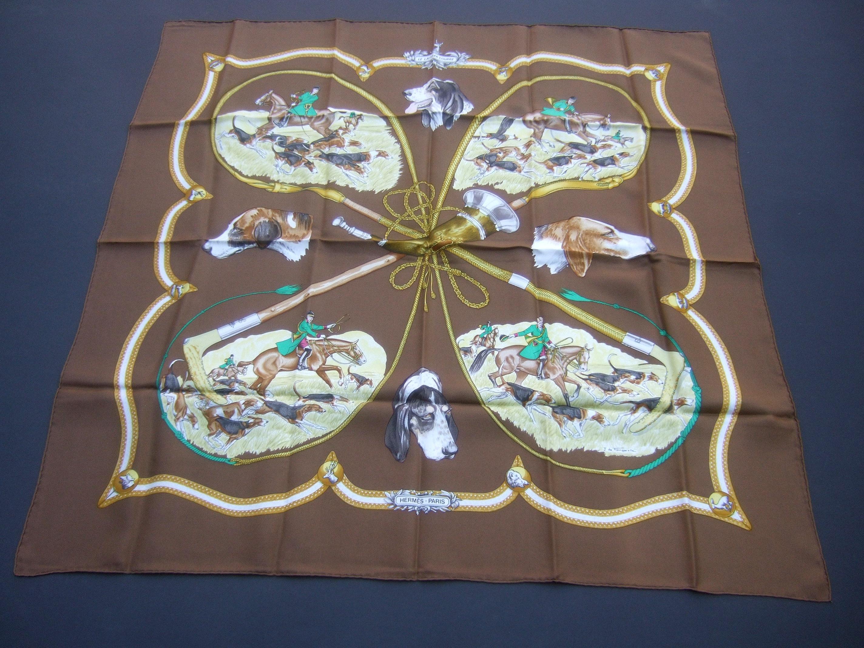 Hermes Paris silk equestrian hunt scene hand rolled scarf c 1990s  35 x 35
The elegant designer scarf is illustrated with a group of huntsman
surrounded with their pack of hunting dogs

The equestrian riders and hunt dogs are illuminated against 
a