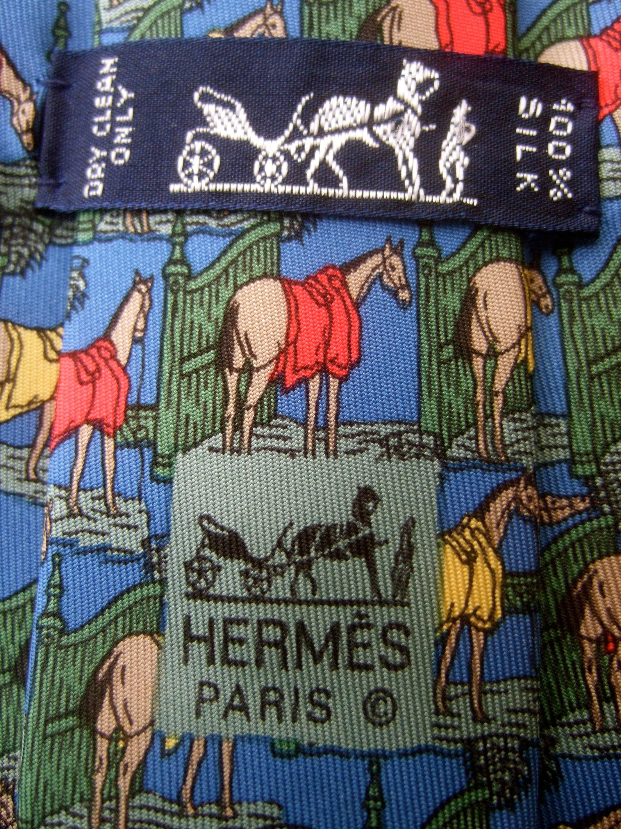 Hermes Paris Silk equine print necktie c 1990 
The stylish designer silk necktie is illustrated 
with a series of majestic horses 

The horses are illuminated against a vibrant blue
background. Makes an elegant accessory for 
the equestrian