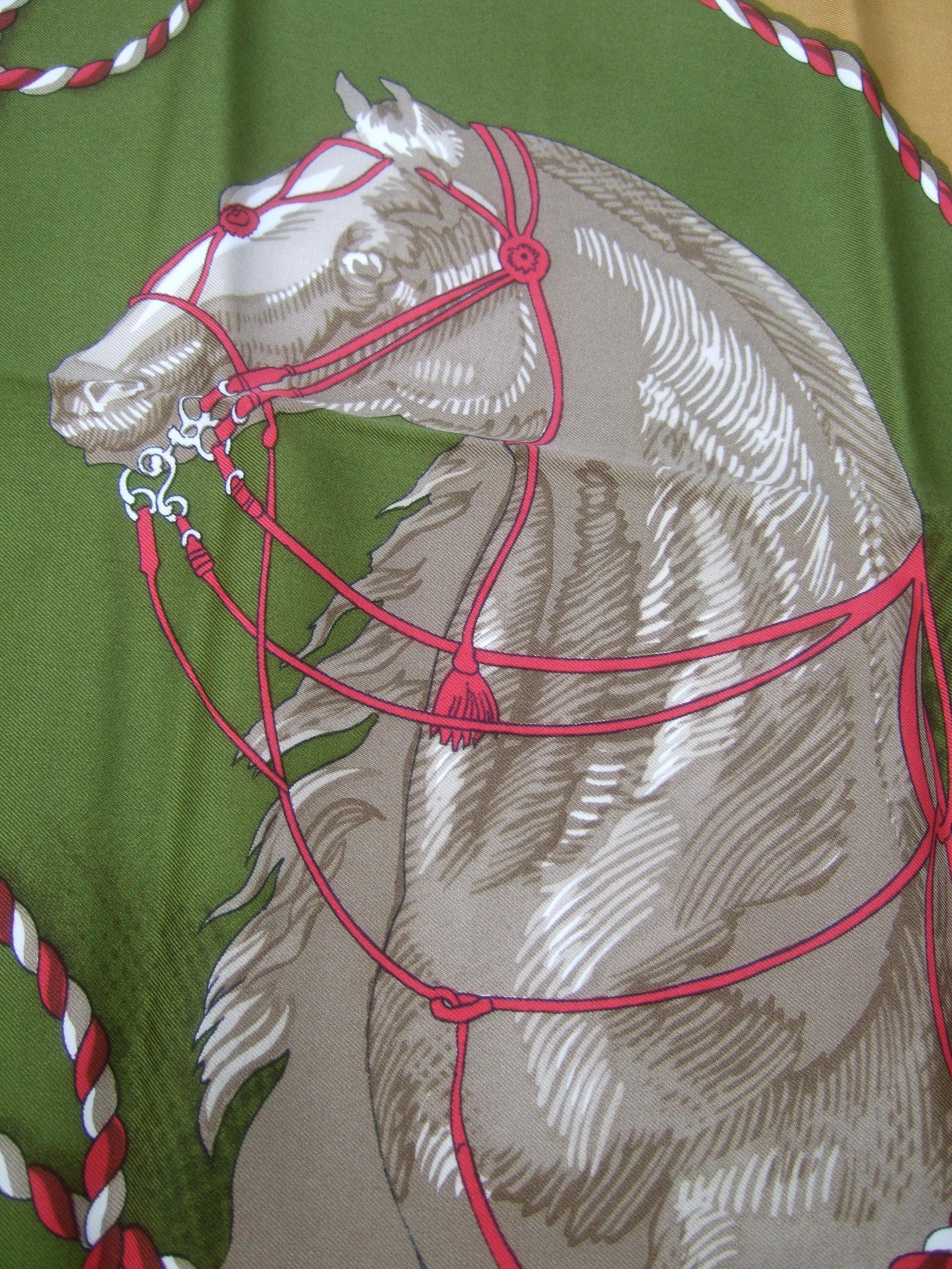 Hermes Paris Silk hand rolled Brides Legeres vintage horse themed scarf c 1980s   33 x 34 in
The luxurious silk hand rolled scarf is illustarted with a collection of majestic
horse figures. The horse figures are illuminated against a moss green &