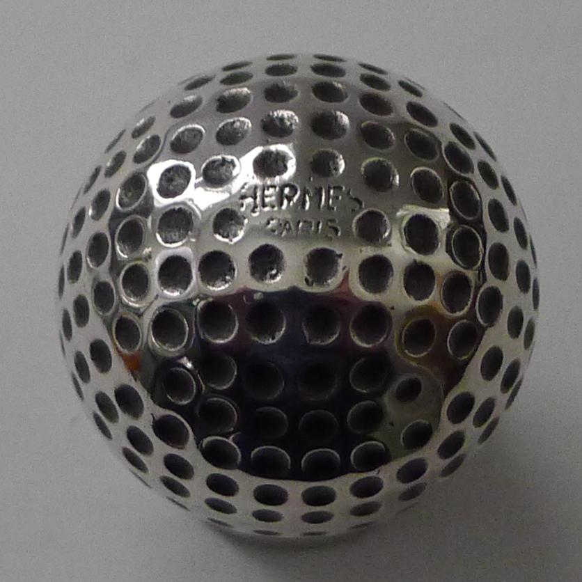 A wonderful vintage vide poche (empty pocket) in silver plate comprising two parts, the dish itself and the golf ball on a stand.

Both pieces are signed 