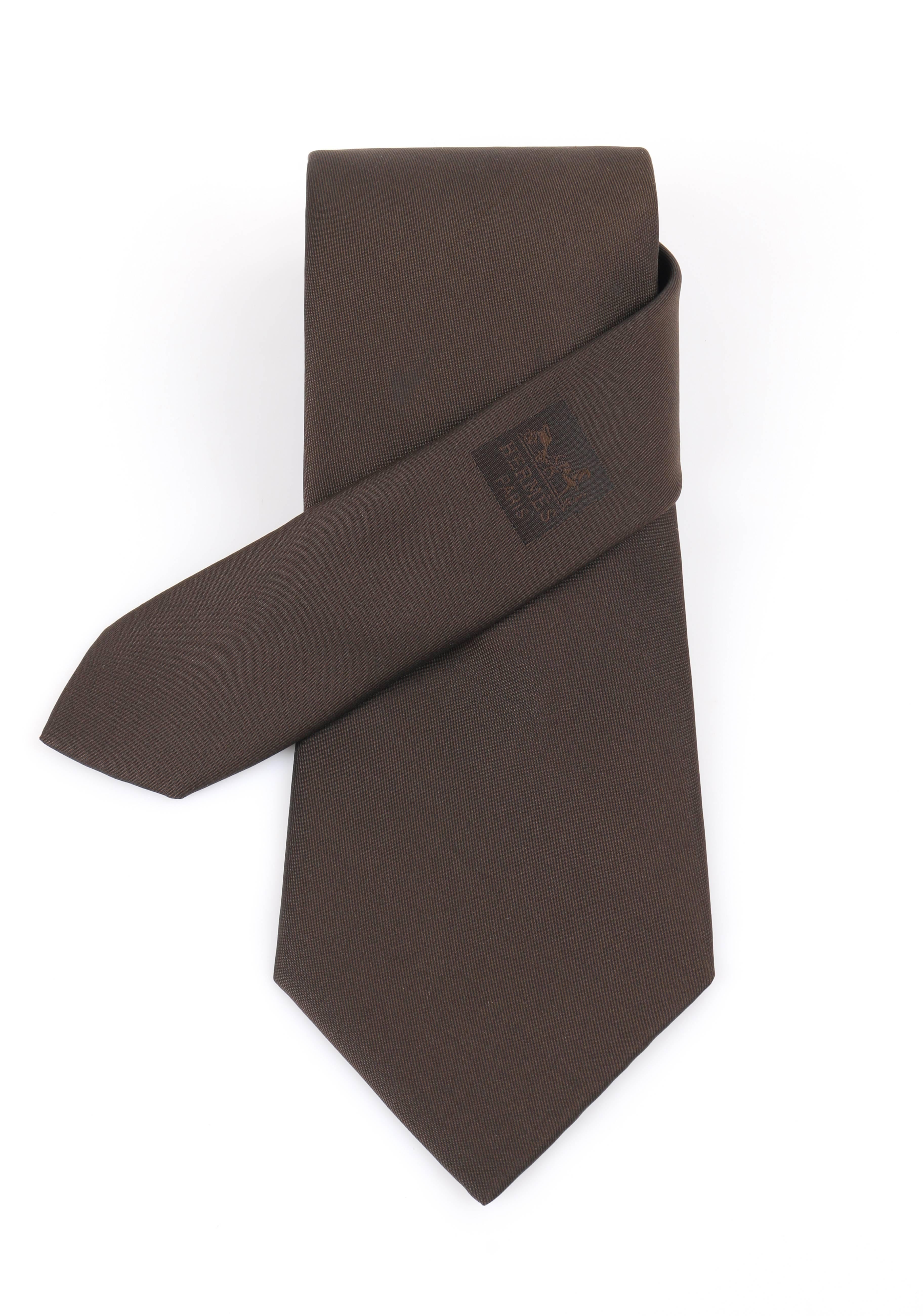 Hermes Paris sold dark brown silk five fold necktie. Solid dark brown silk body. 