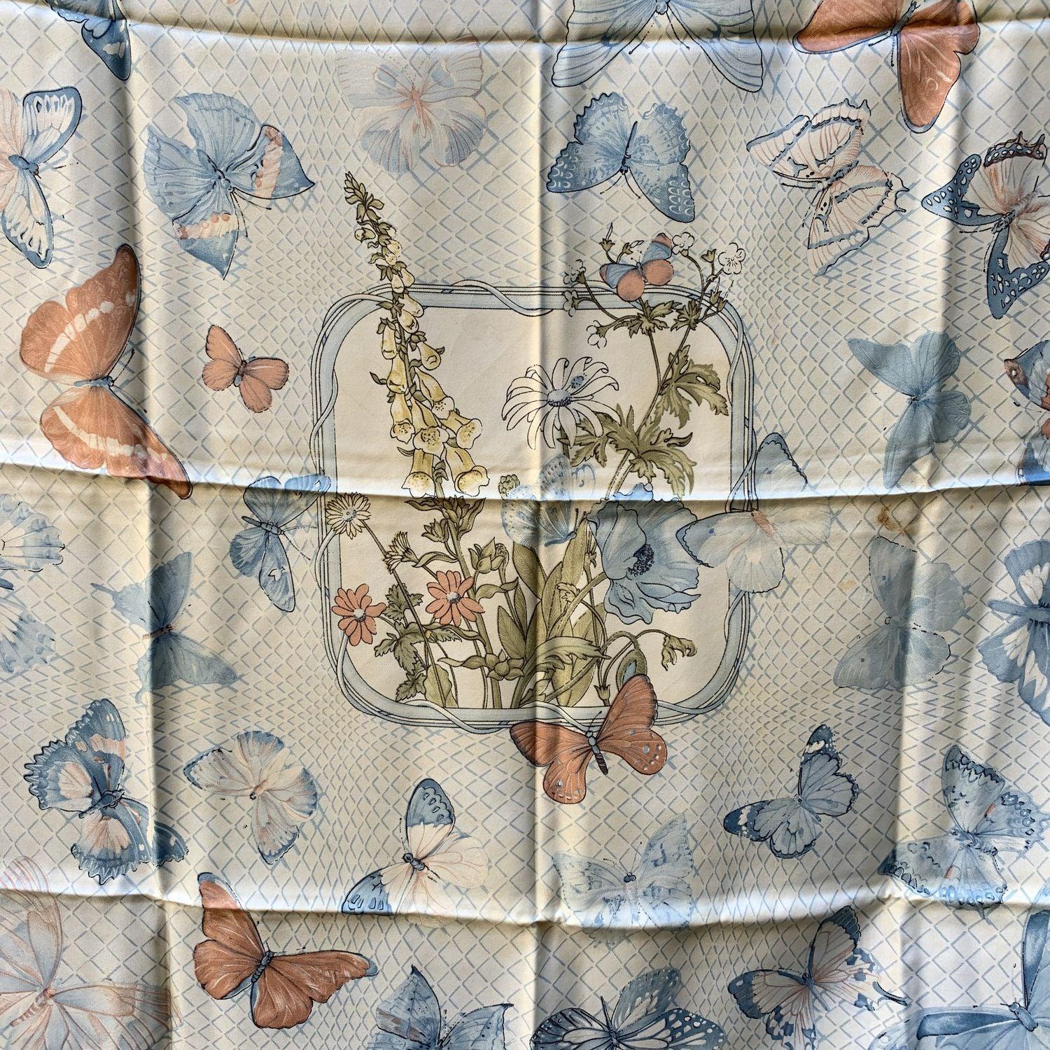 HERMES Silk scarf named 'Farandole', created by artist Caty Latham, and first issued in 1985. It was re-issued in 1990 and in 2006. Beautiful butterflies design. Light blue colorway. 100% Silk. Hand rolled edges. Approx measurements: 35 x 35 inches