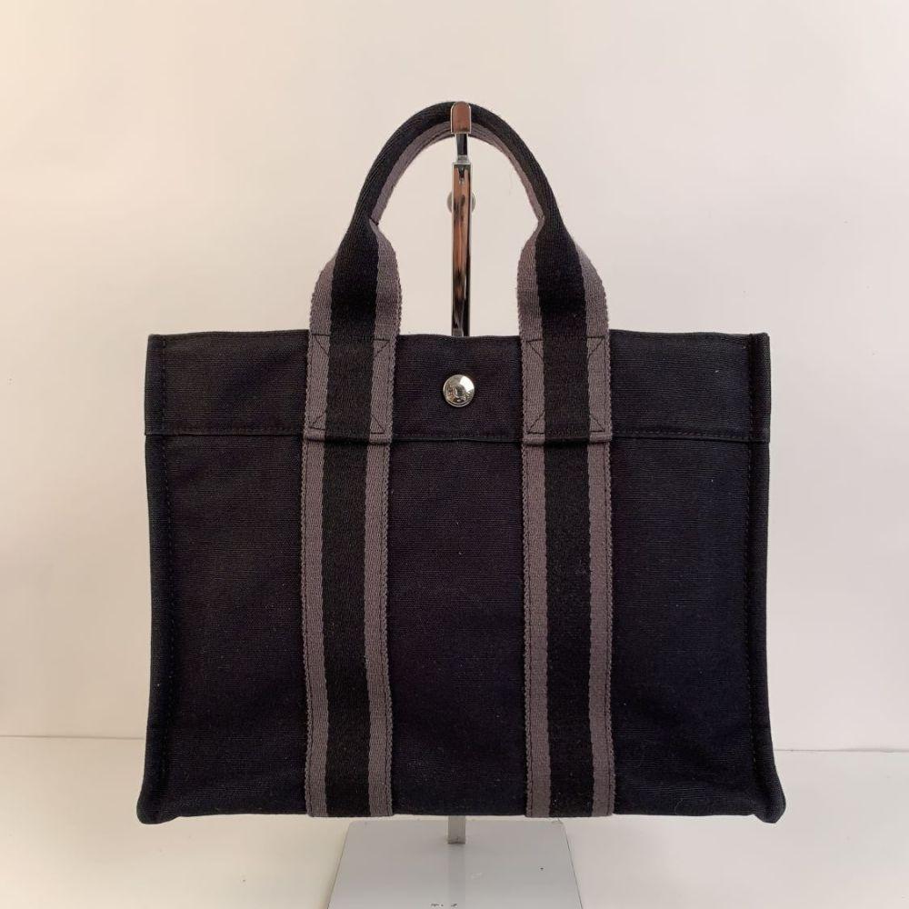 - Model: 'HERMES FOURRE TOUT - PM' Tote handbag
- Made in France
- Color: Black with Gray stripes
- Material: 100% cotton
- It has snaps on both ends for expansion
- Durable canvas handles, perfect for casual and everyday use.
- Open top with middle