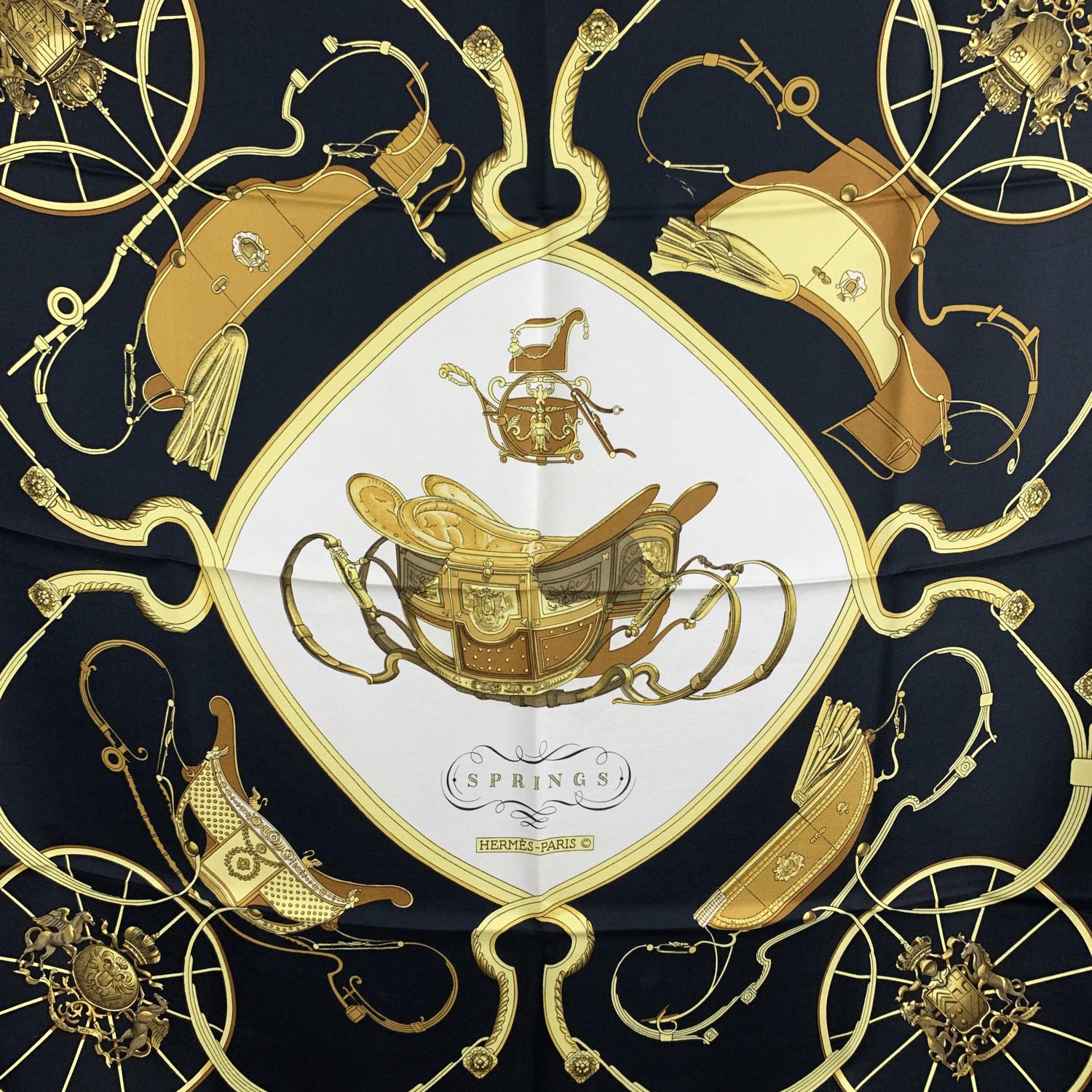 Hermes Paris Vintage Silk Scarf 'Springs' . It depicts in its center the phaeton carriage belonging to Napoleon I's son. Artist :Philippe Ledoux. First Issue : 1974. Main colors are black, white and yellow gold. Hand rolled hem. Fabric / Material: