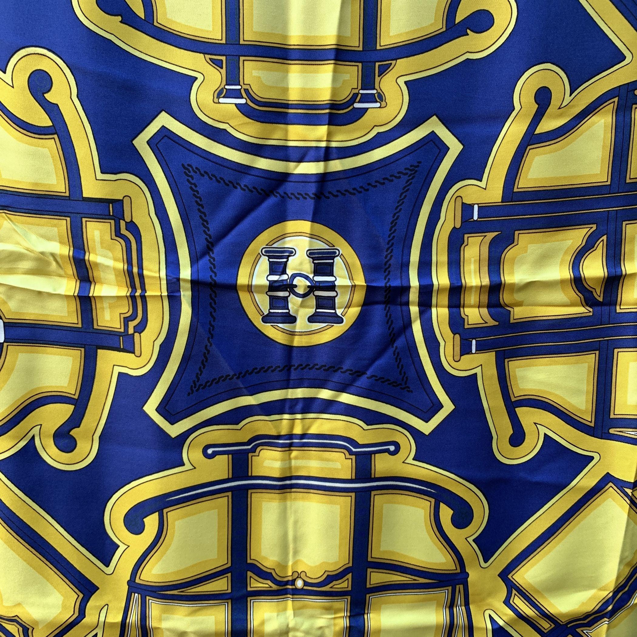 Step back in time with the Hermès Paris Vintage Blue Les Berlines scarf, a masterpiece designed by Françoise de la Perrière in 1972. This first edition silk scarf pays homage to the historical Berlin carriage, a mode of transport that first appeared